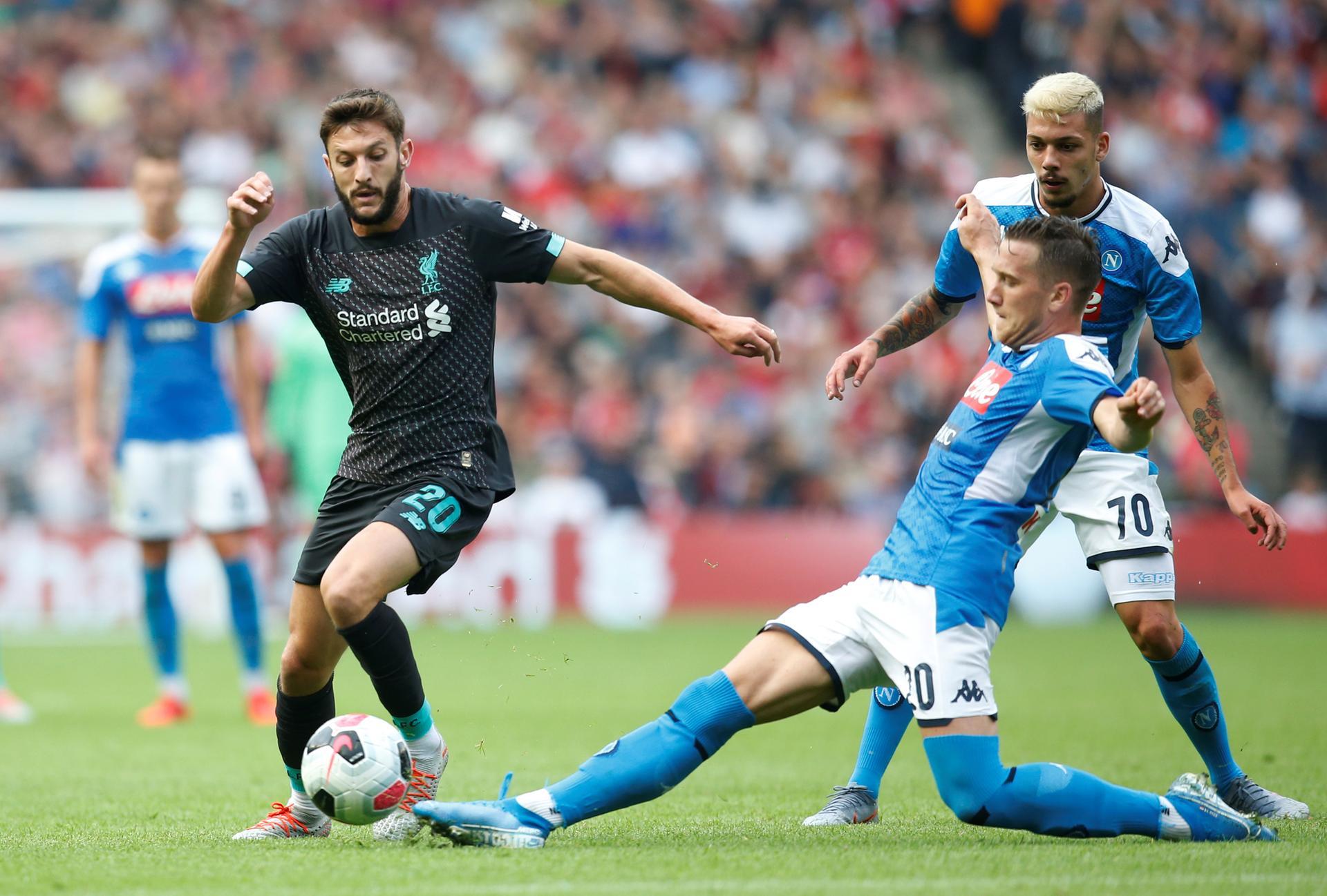 Liverpool's Adam Lallana, left, in action with Napoli's Piotr Zielinski. Reuters