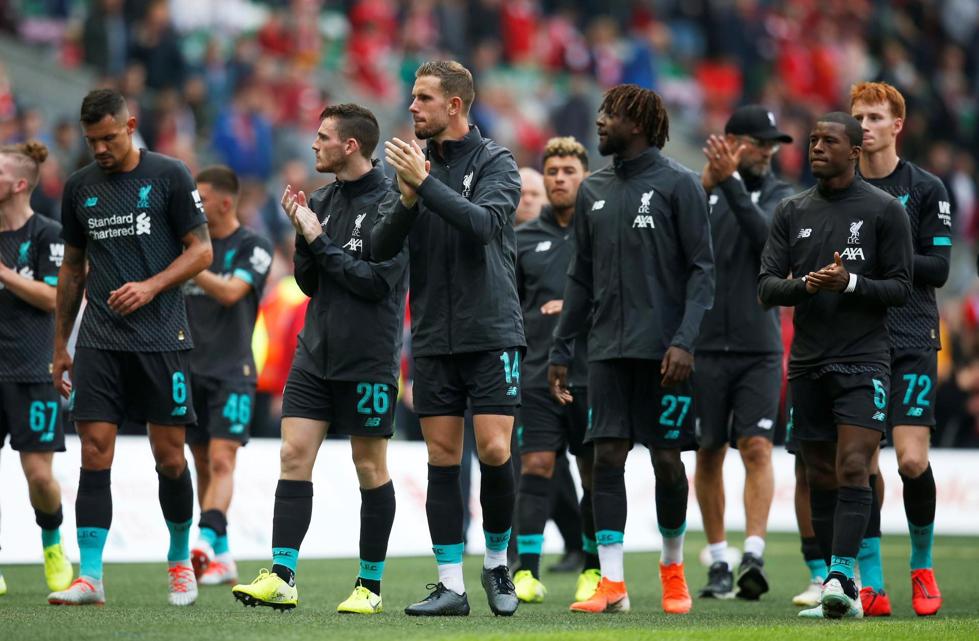 Liverpool players applaud the fans after the match. Reuters