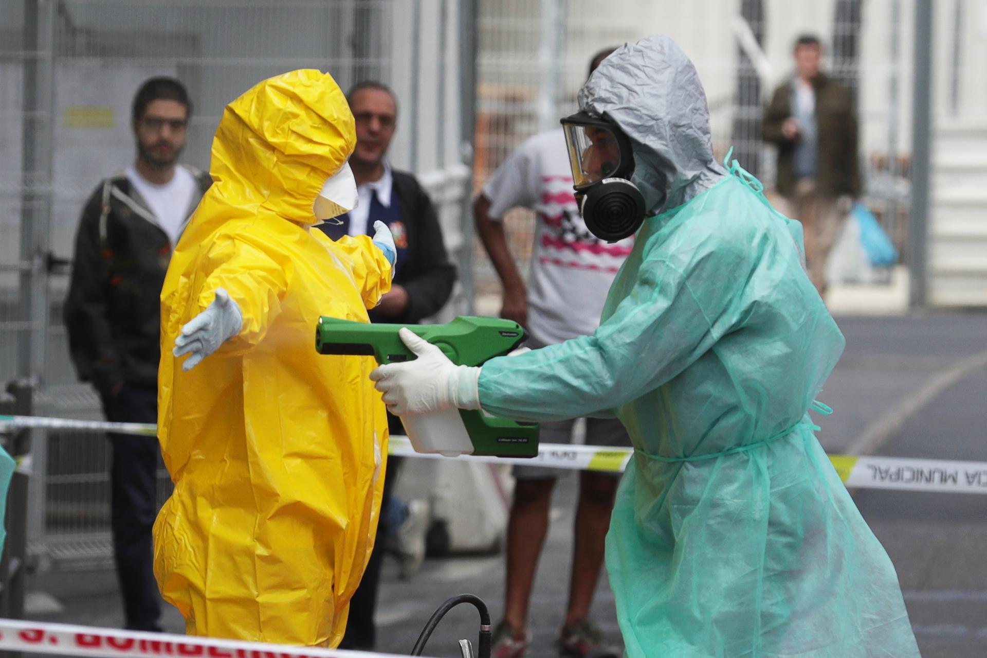 PORTUGAL: Members of the National Institute for Medical Emergency and the Public Security Police (PSP) conduct an evacuation operation at a hostel in Lisbon, on April 19, 2020. EPA