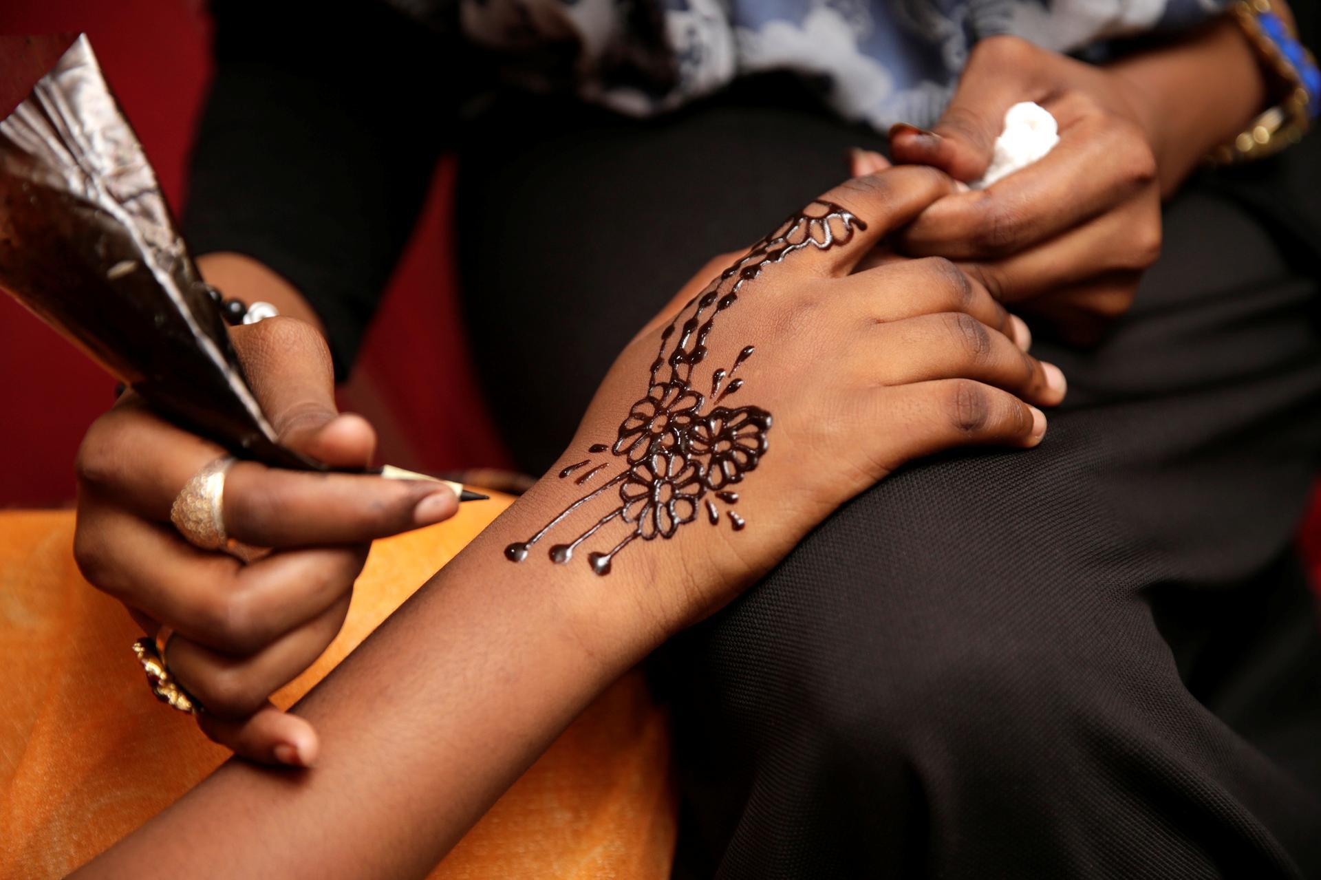 Woman Hand with black henna tattoo on jewelry Indian bride girl hand with black  mehndi tattoo Stock Photo  Adobe Stock