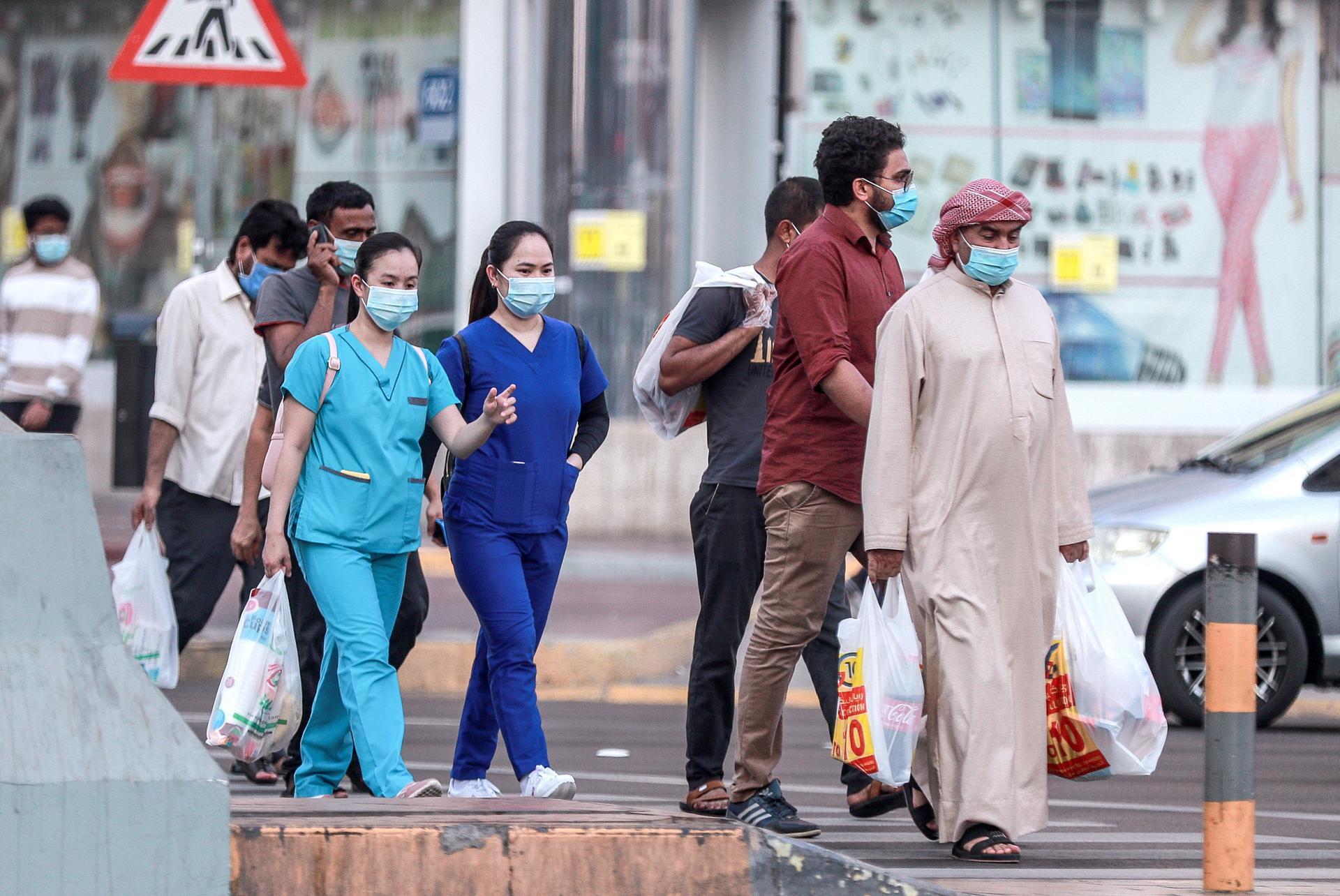 Residents wear face masks to prevent the spread of Covid-19 in Abu Dhabi. Victor Besa / The National