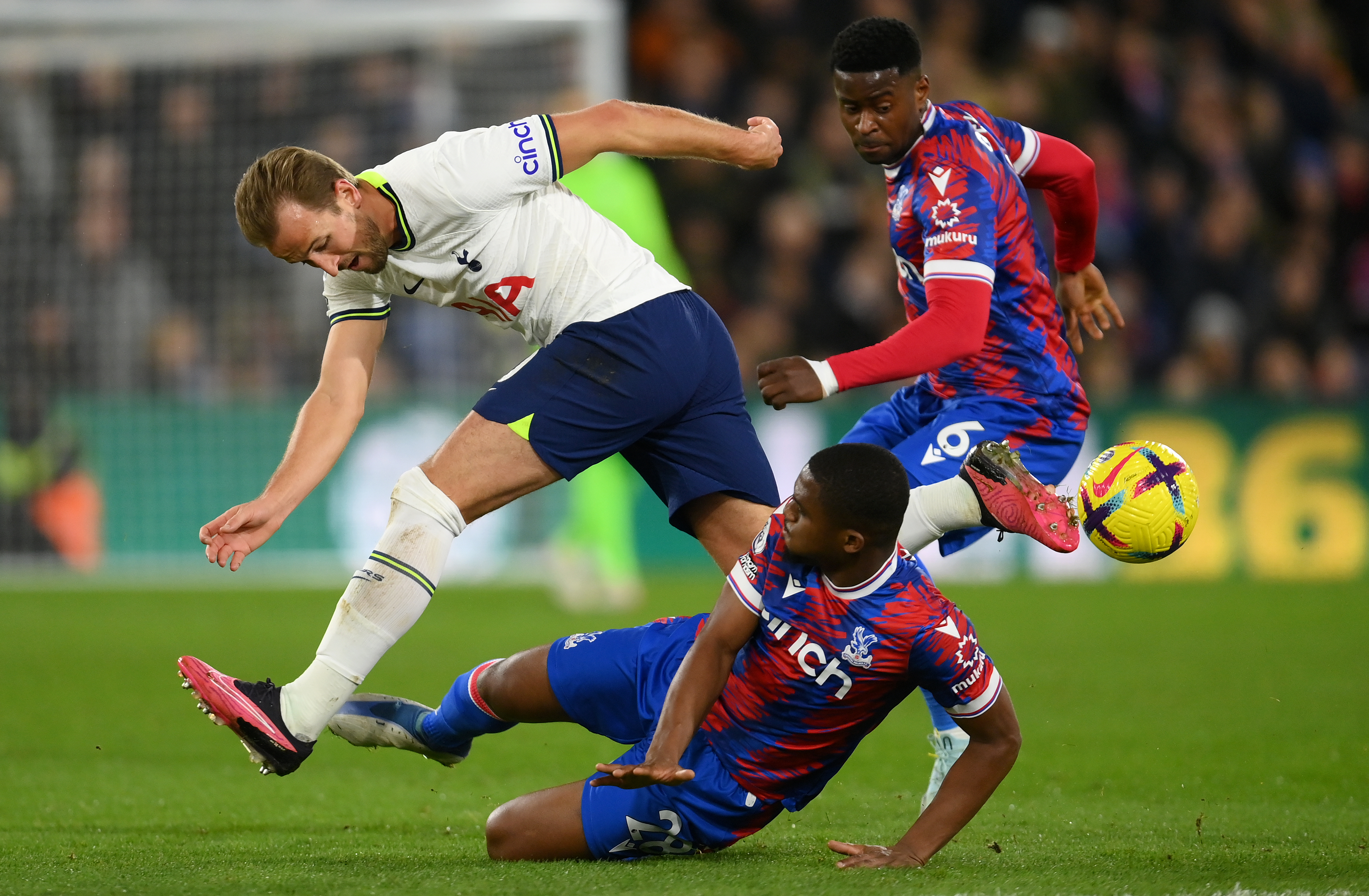 Spurs striker Harry Kane is tackled by Cheick Doucoure and Marc Guehi of Crystal Palace. Getty