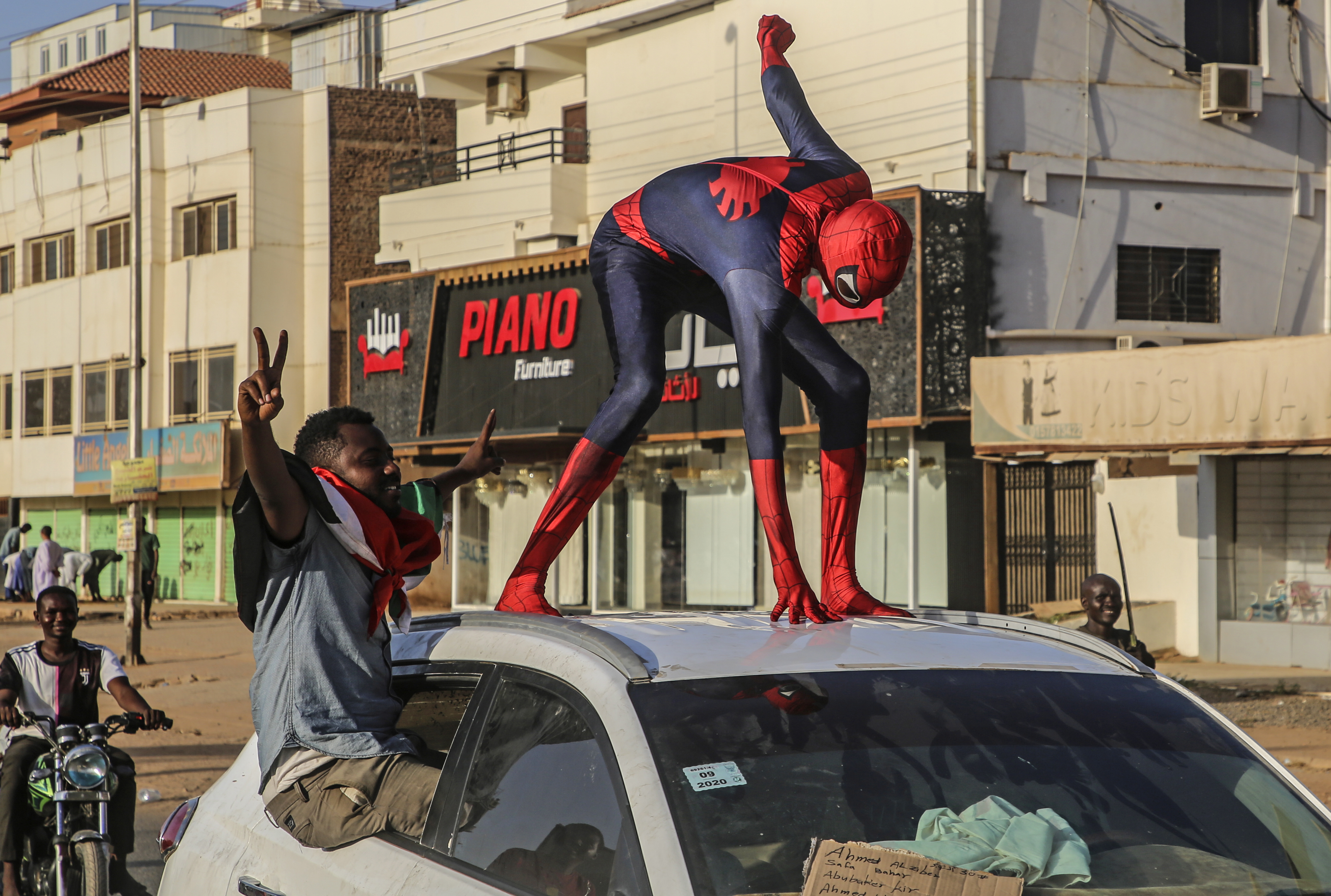 A Sudanese protester dressed up as Spider-Man, stands on car during an anti-coup protest in the capital Khartoum. EPA
