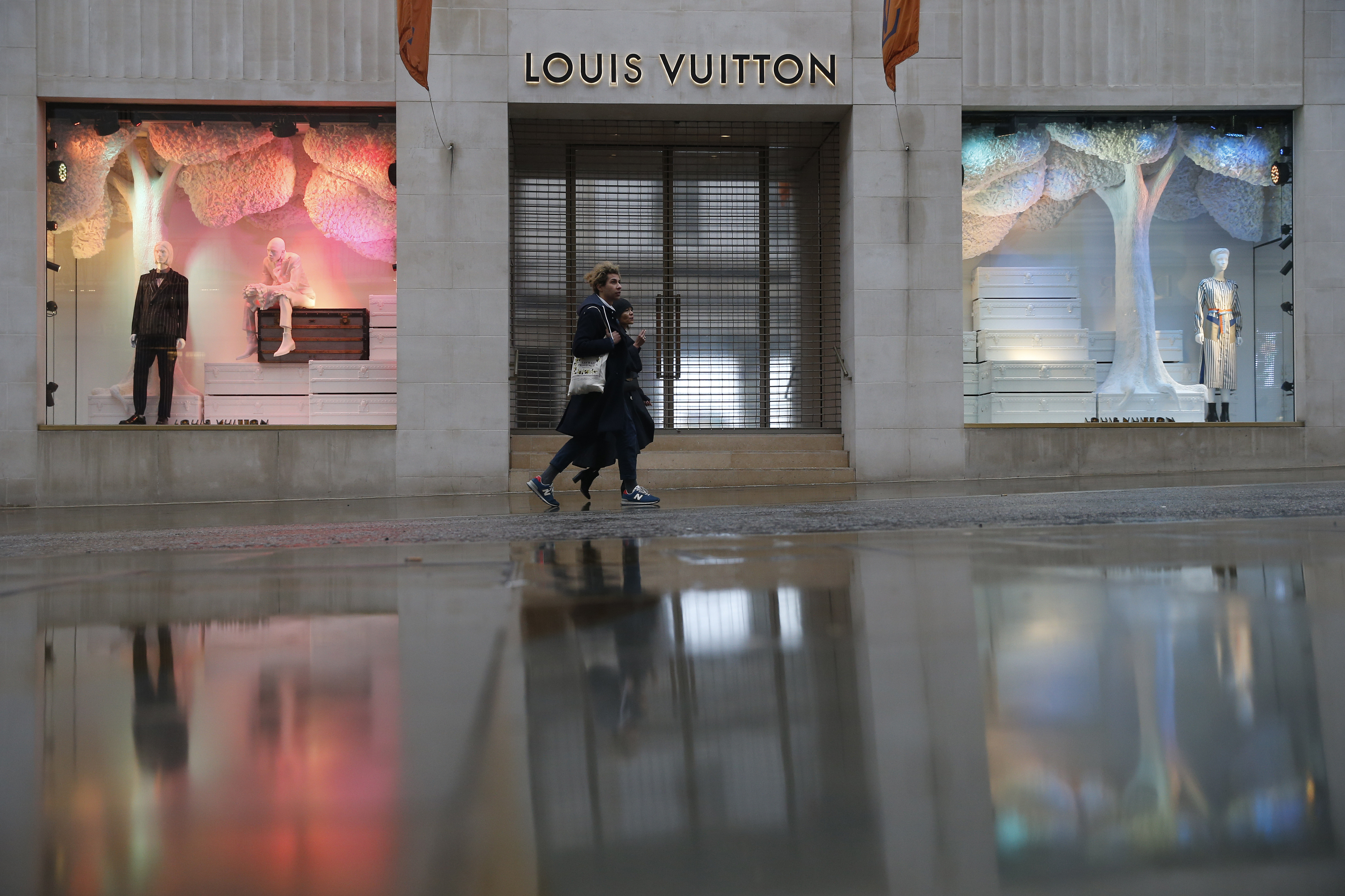TOKYO, Japan - A sales clerk shows a Louis Vuitton merchandise at