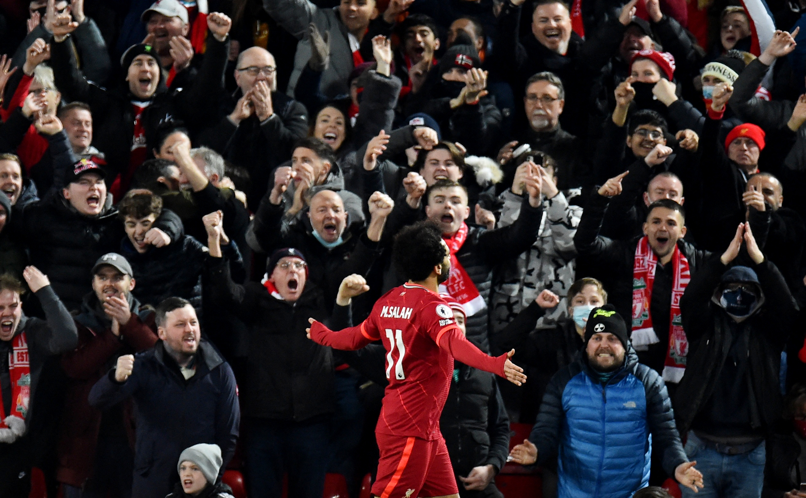 Liverpool's Mohamed Salah exchanges his shirt with a member of the crowd  for a present after the UEFA Champions League, Group C match at Anfield,  Liverpool Stock Photo - Alamy