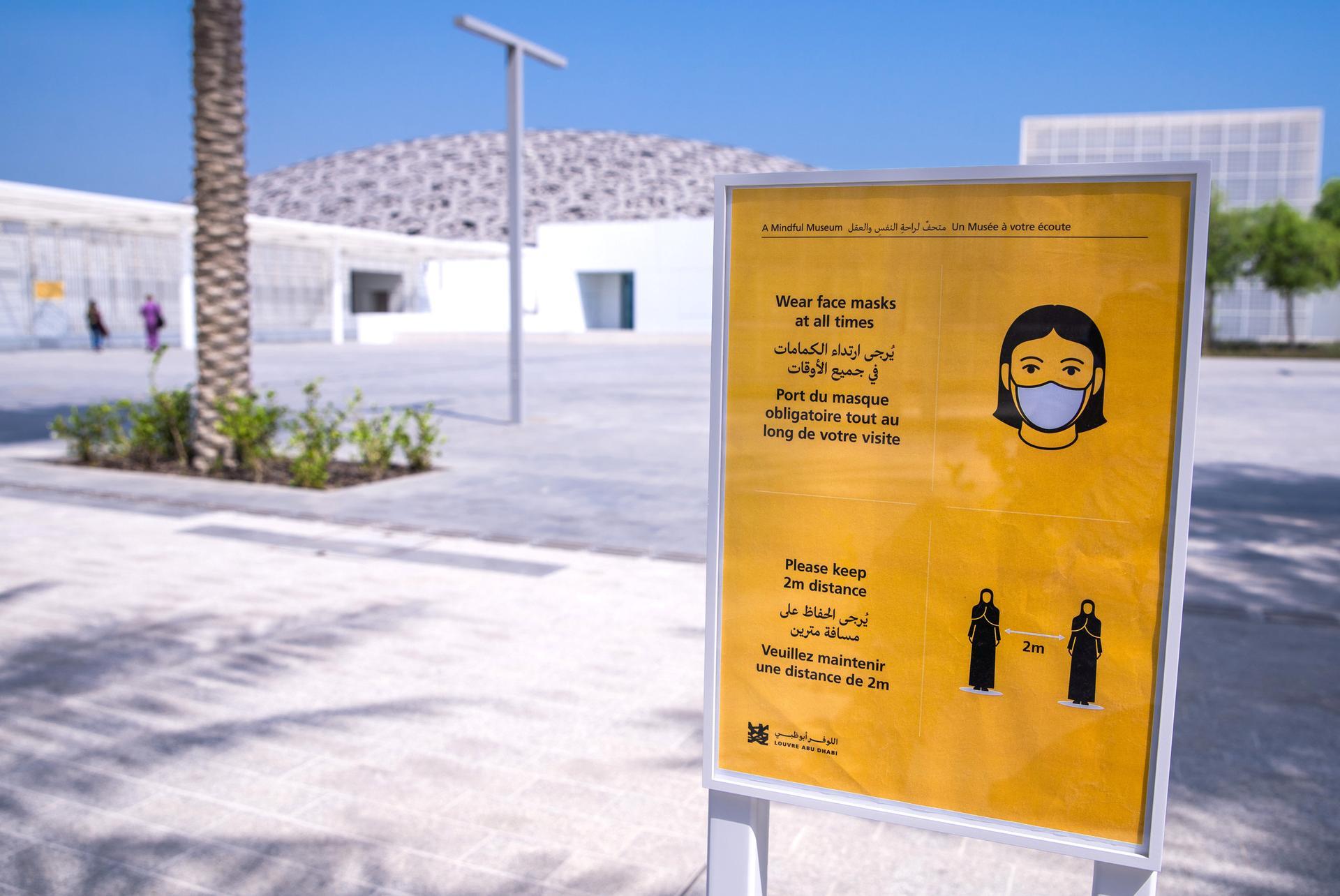 Visitors arriving at Louvre Abu Dhabi on Saadiyat Island are reminded of precautions against Covid-19. Victor Besa / The National