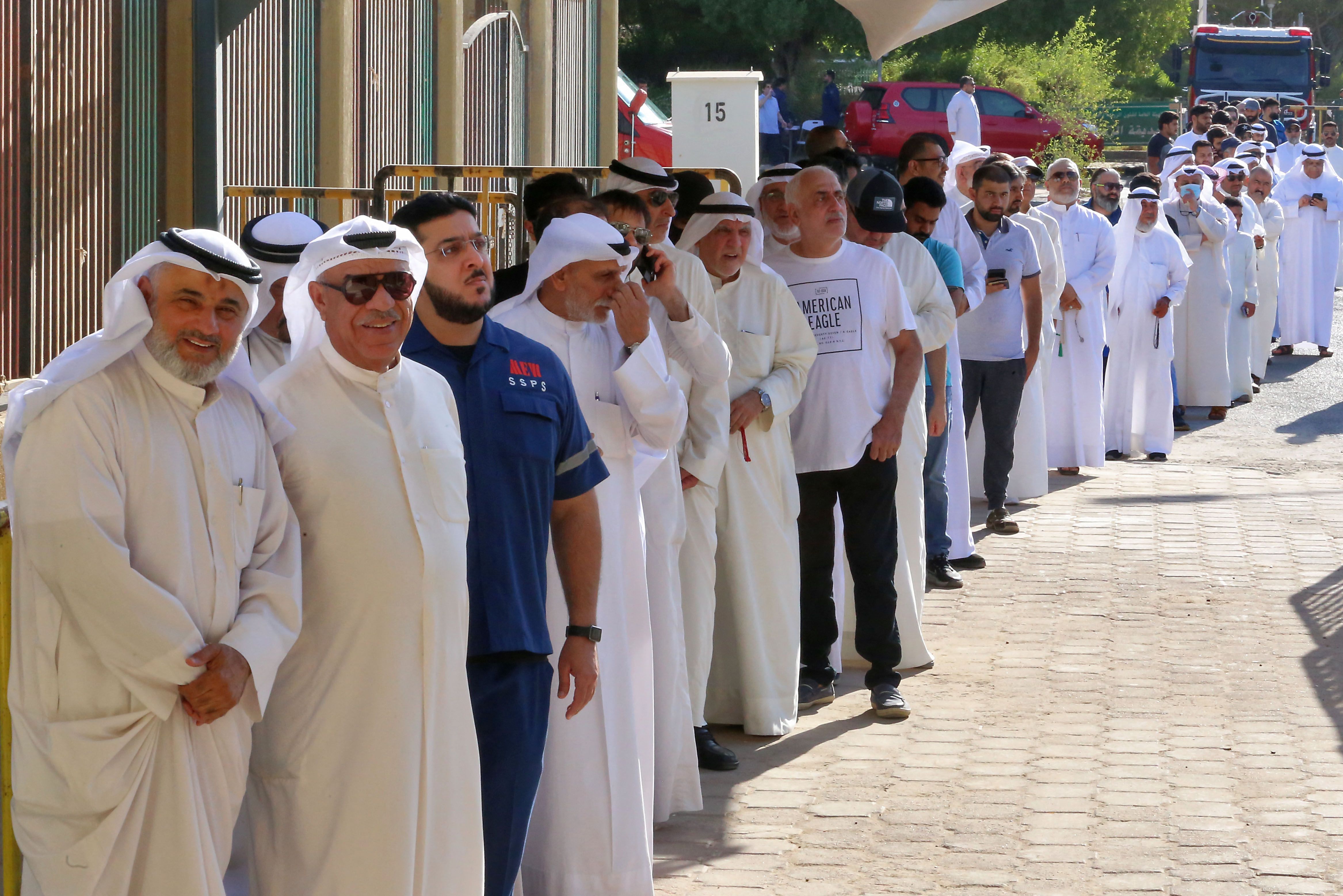 Kuwaitis queue up outside a polling station to vote during parliamentary elections in Kuwait City. Kuwait is holding its most inclusive elections in a decade, with some opposition groups ending a boycott after the country's royal rulers pledged not to interfere with Parliament. AFP