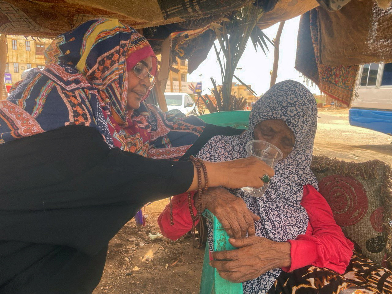 A woman helps another after fleeing clashes between the paramilitary Rapid Support Forces and the army in Khartoum. Reuters