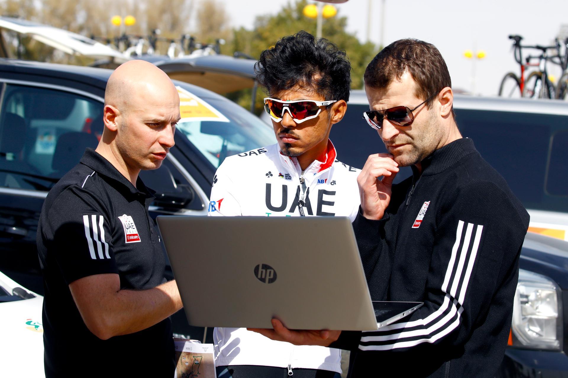 Yousif Mirza, centre, analyses data with UAE Team Emirates staff. Courtesy Bettini photo