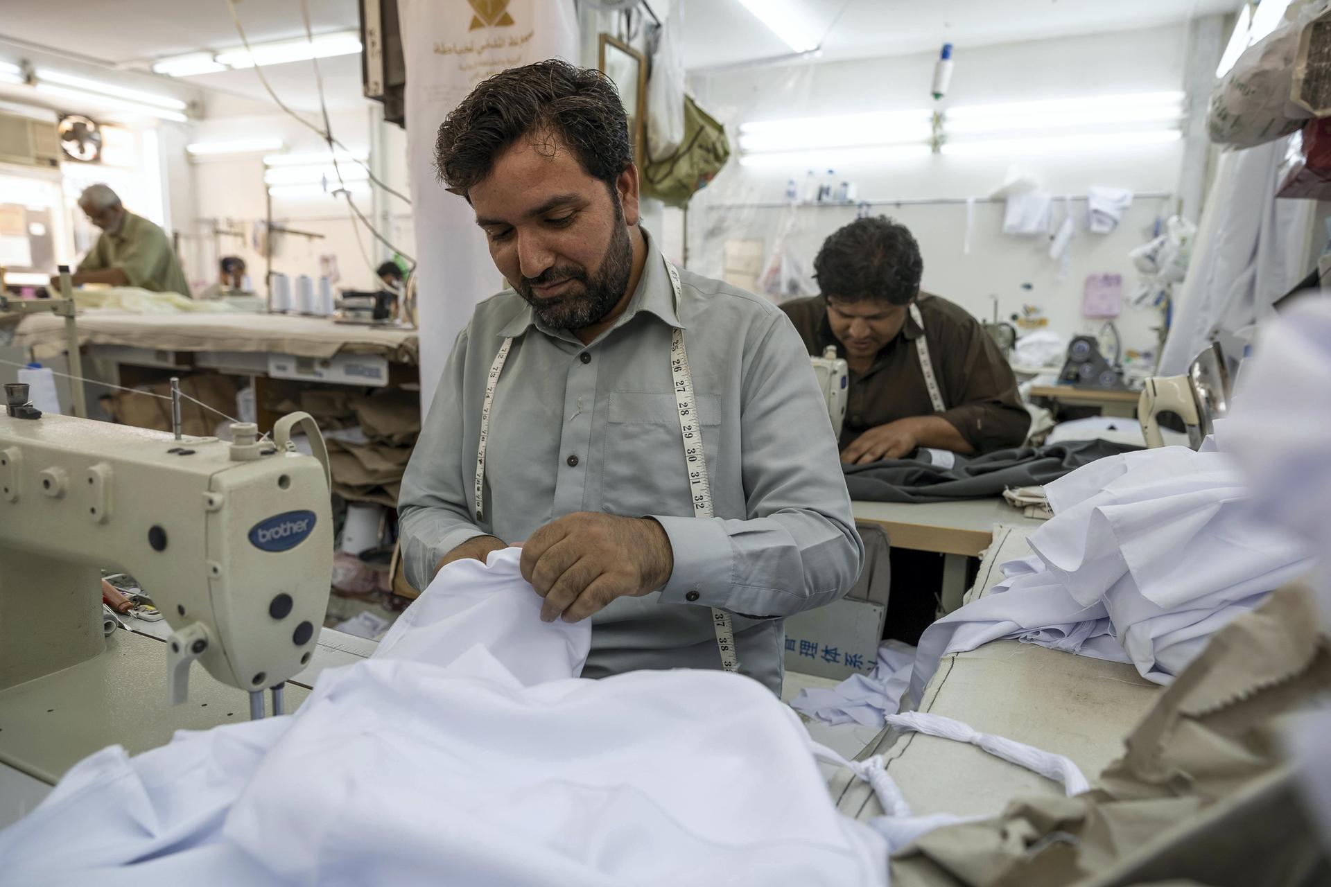 Tailors at a garment shop in Satwa prepare and finish sowing Eid clothes for the upcoming end of the Holy Month of Ramadan. Antonie Robertson / The National