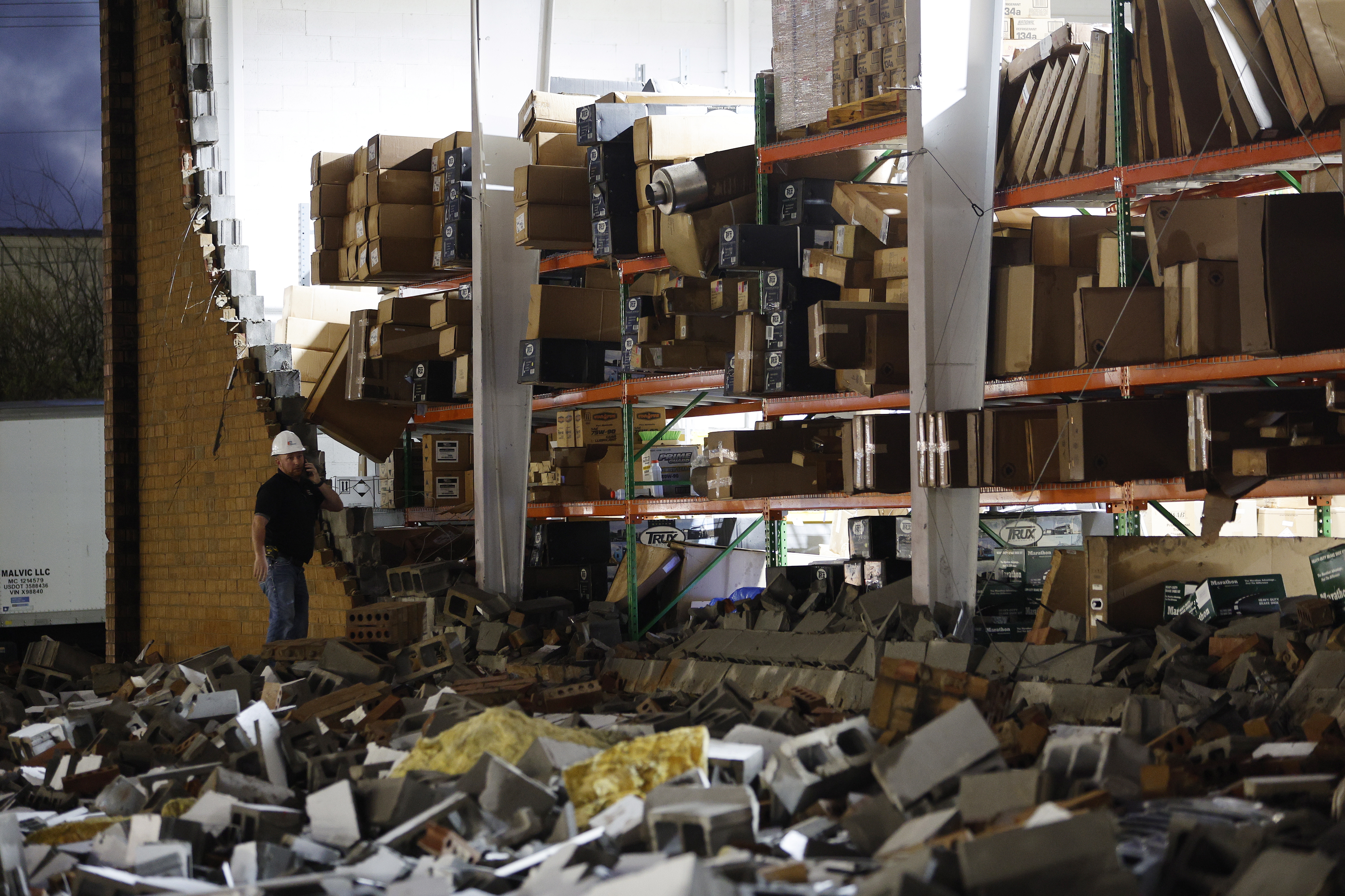 Workers assess the damage caused by a tornado to an automotive parts warehouse in Austell, Georgia. EPA