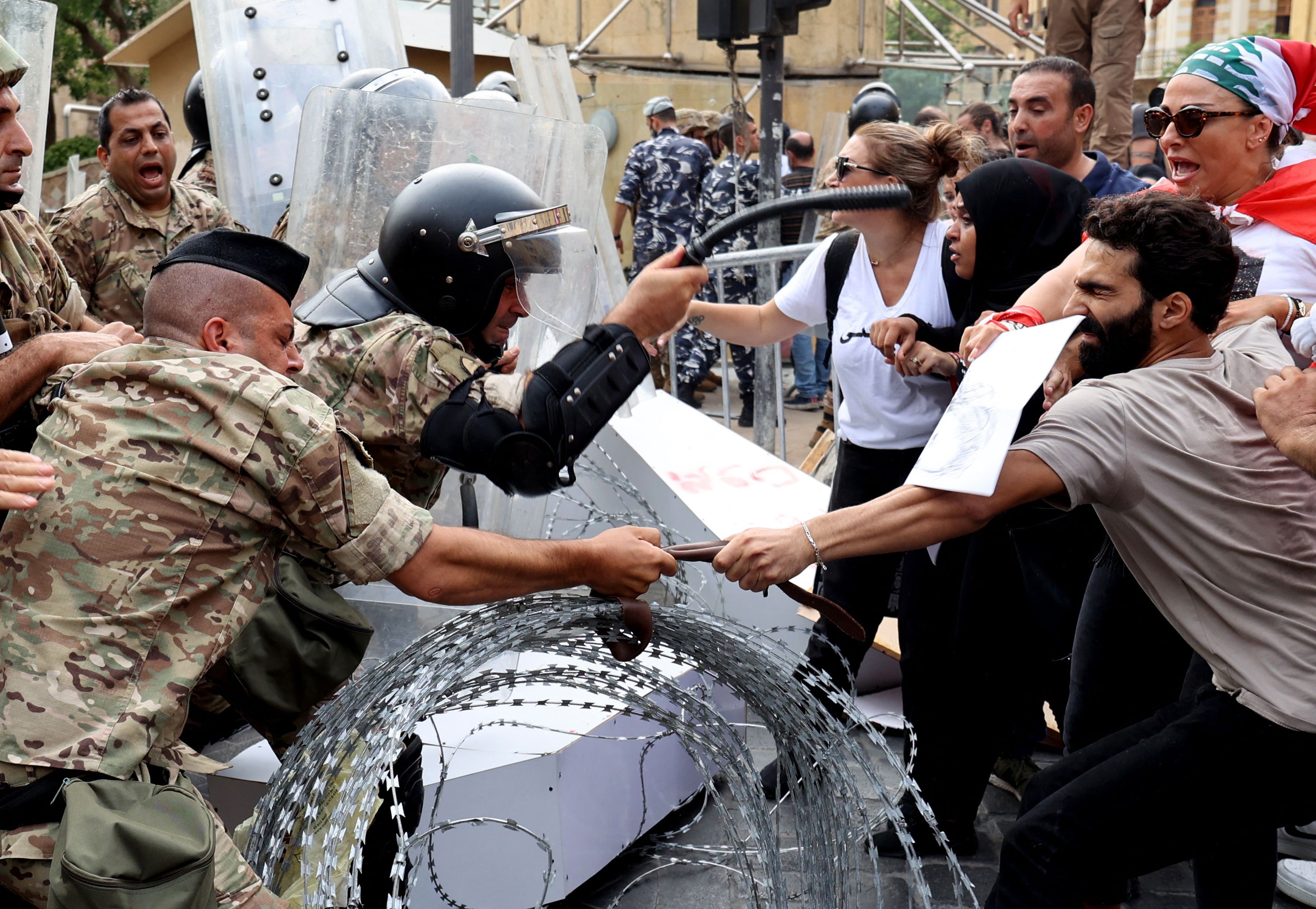 Activists confront soldiers guarding the entrance of Lebanon's parliament building, on August 4, as the nation marked two years since a giant explosion ripped through Beirut. AFP