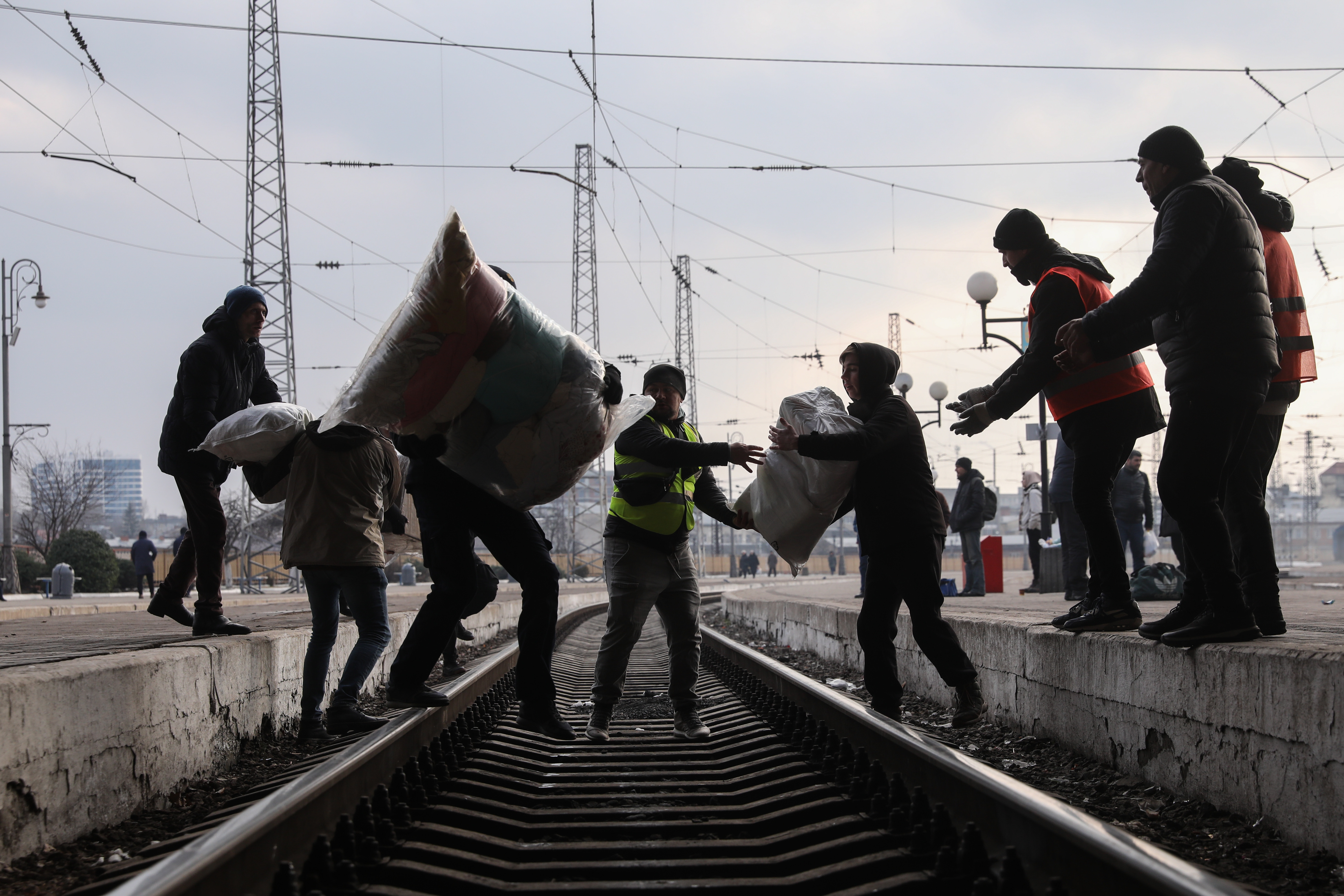 Volunteers carry medical aid and necessities at a train station in Lviv. EPA