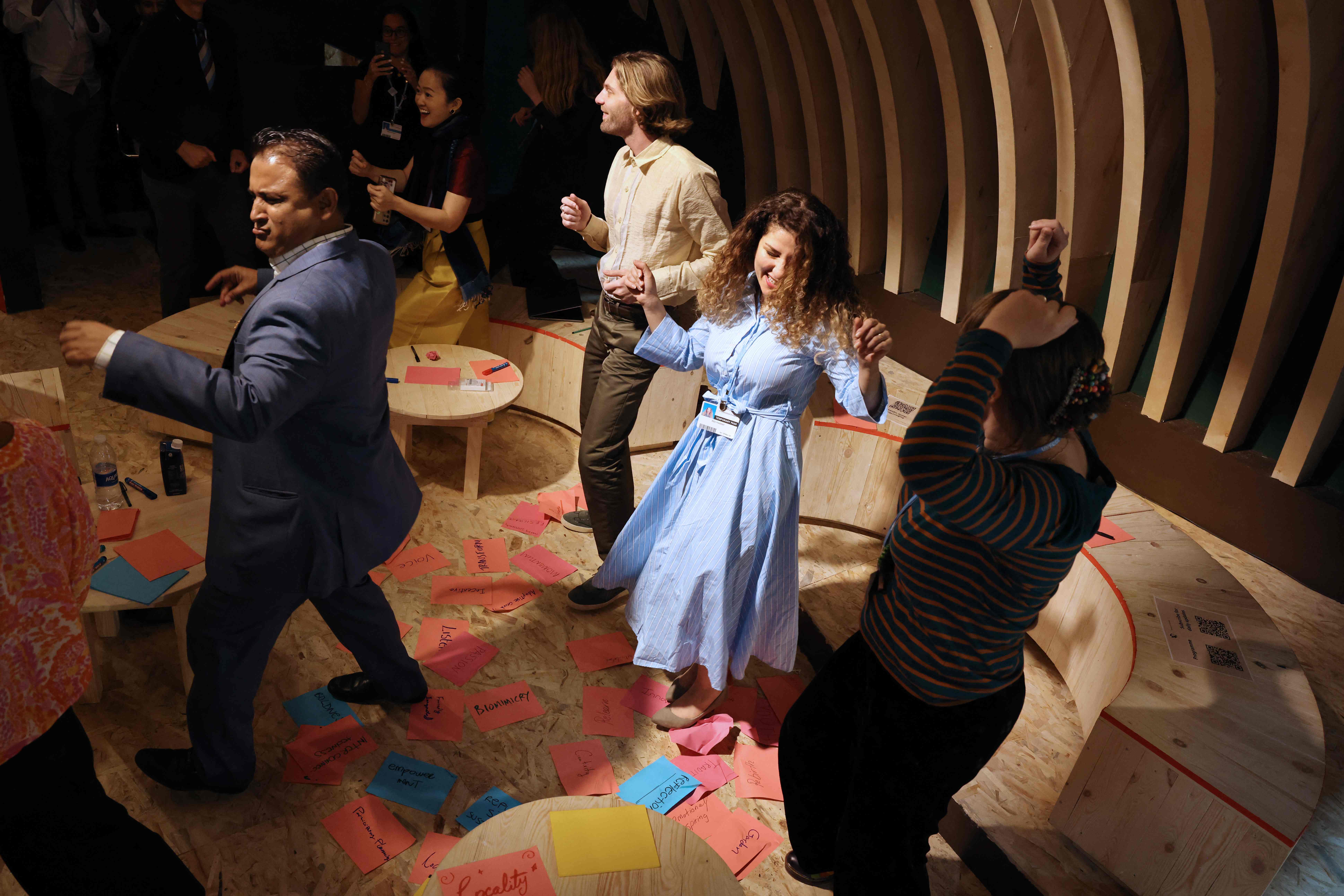 Activists dancing during a discussion on leaflets at the Cop27 climate conference, taking place in Sharm El Sheikh, Egypt. AFP