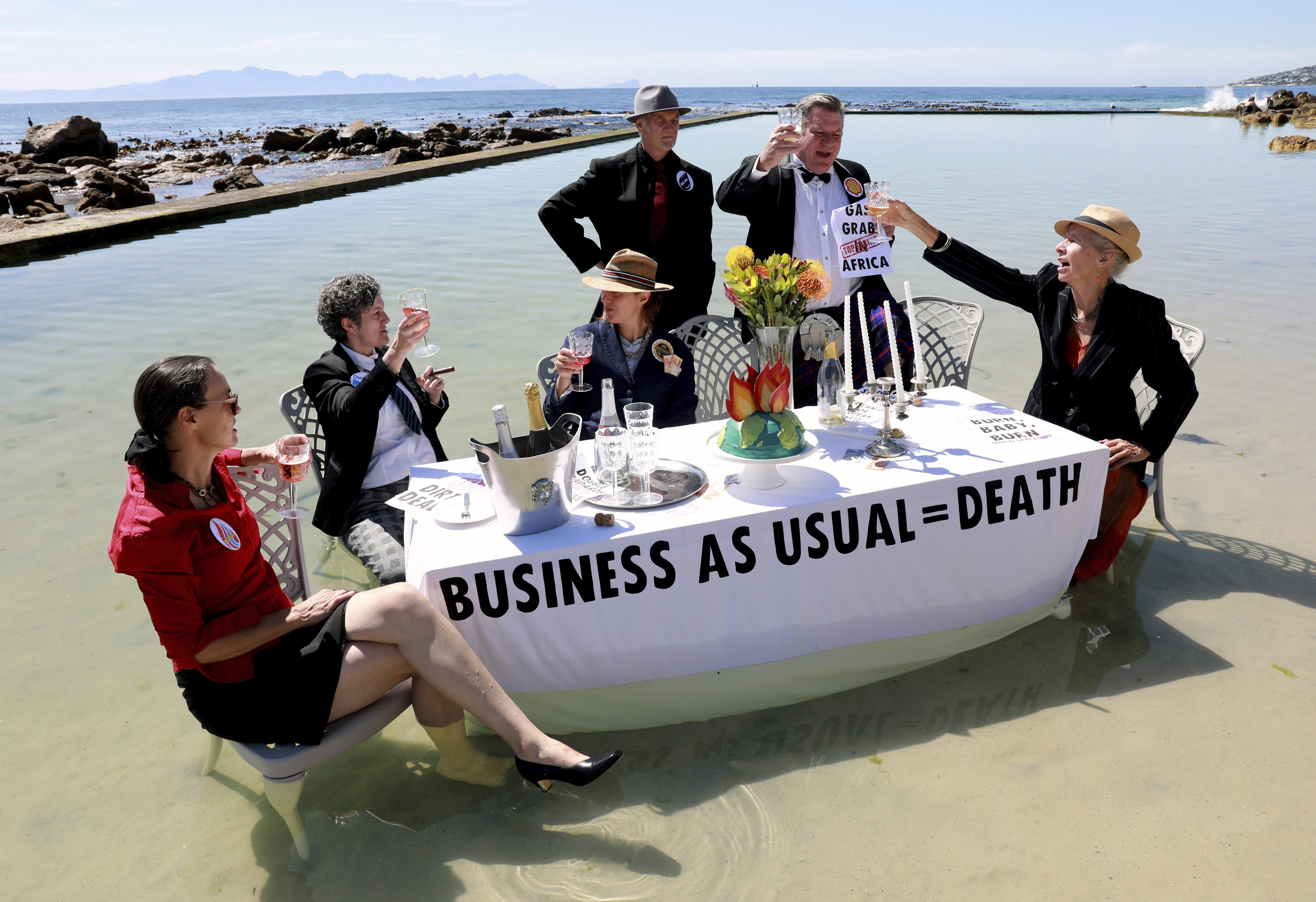 Members of Extinction Rebellion stage a protest at the Glencairn tidal pool outside Cape Town, South Africa to mark Cop27's 'Water Day'. AP