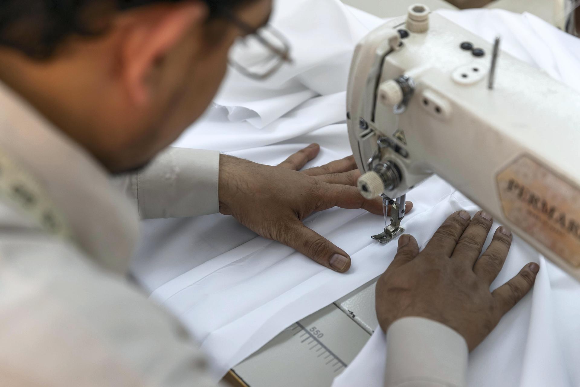 Tailors at a garment shop in Satwa prepare and finish sowing Eid clothes for the upcoming end of the Holy Month of Ramadan. Antonie Robertson / The National