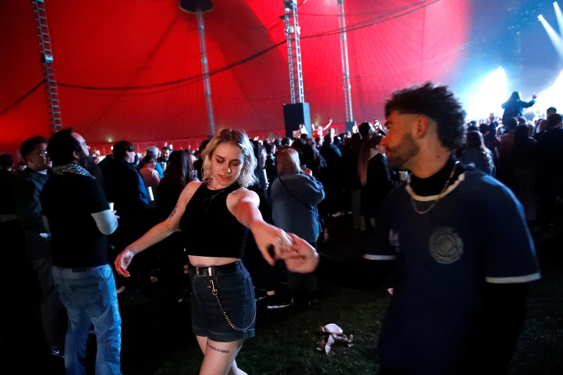 People dance at the UK's first post-lockdown music festival. Reuters
