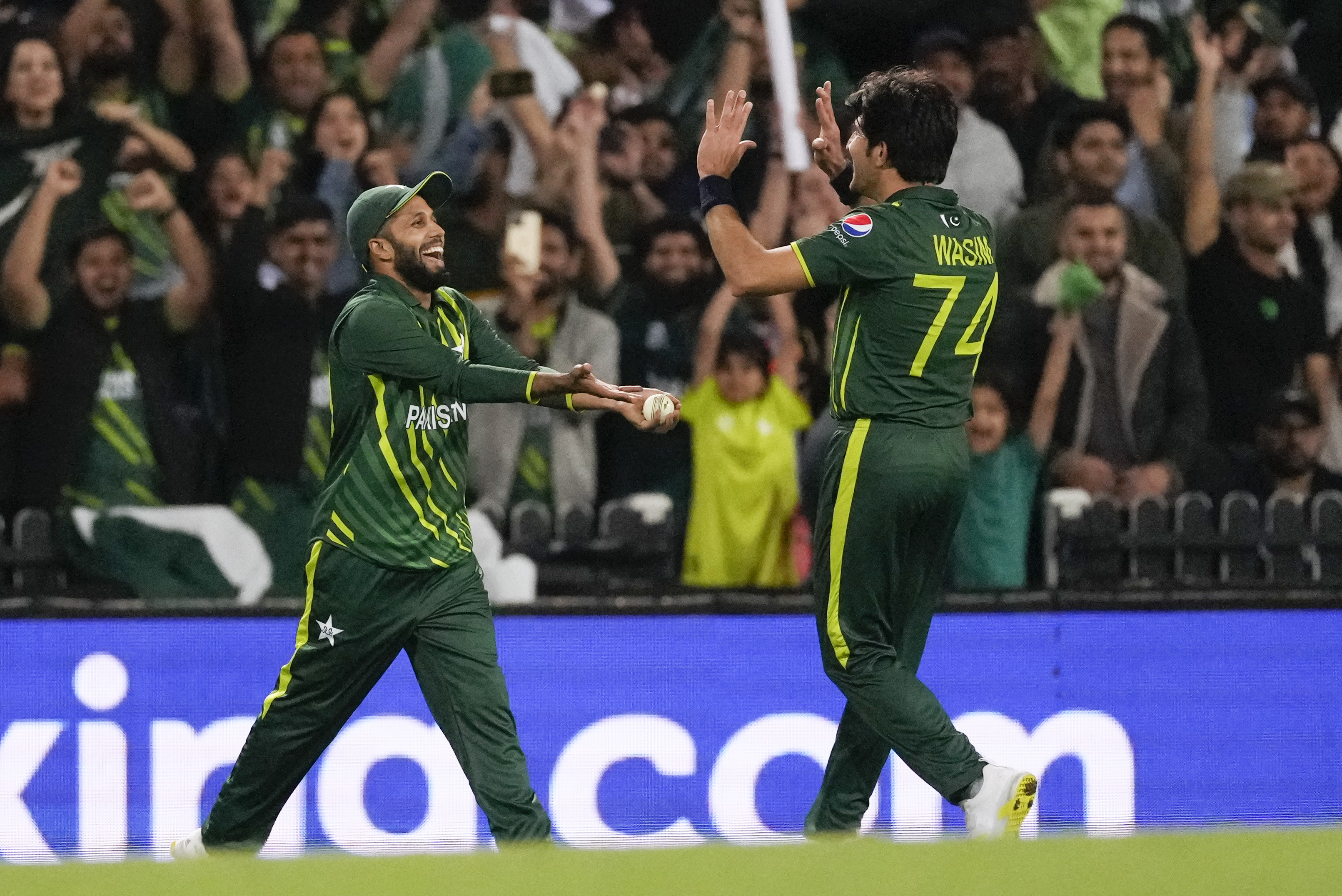 Pakistan's Mohammad Haris, left, is congratulated by teammate Mohammad Wasim after taking a catch to dismiss South Africa's Anrich Nortje. AP