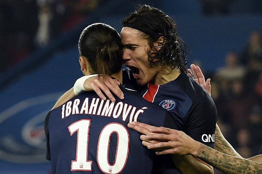 Paris Saint-Germain's Edinson Cavani celebrates with Zlatan Ibrahimovic after a goal in PSG's Ligue 1 win over Saint-Etienne on Sunday. Miguel Medina / AFP / October 25, 2015