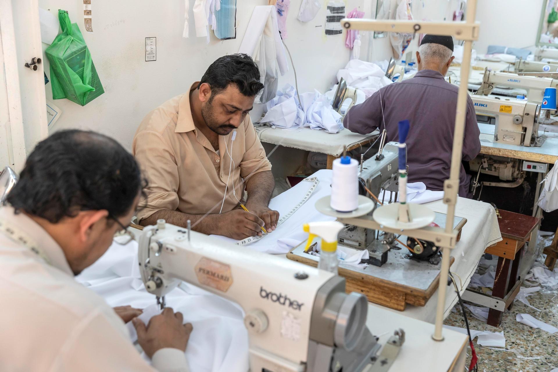 Tailors at a garment shop in Satwa prepare and finish sowing Eid clothes for the upcoming end of the Holy Month of Ramadan. Antonie Robertson / The National