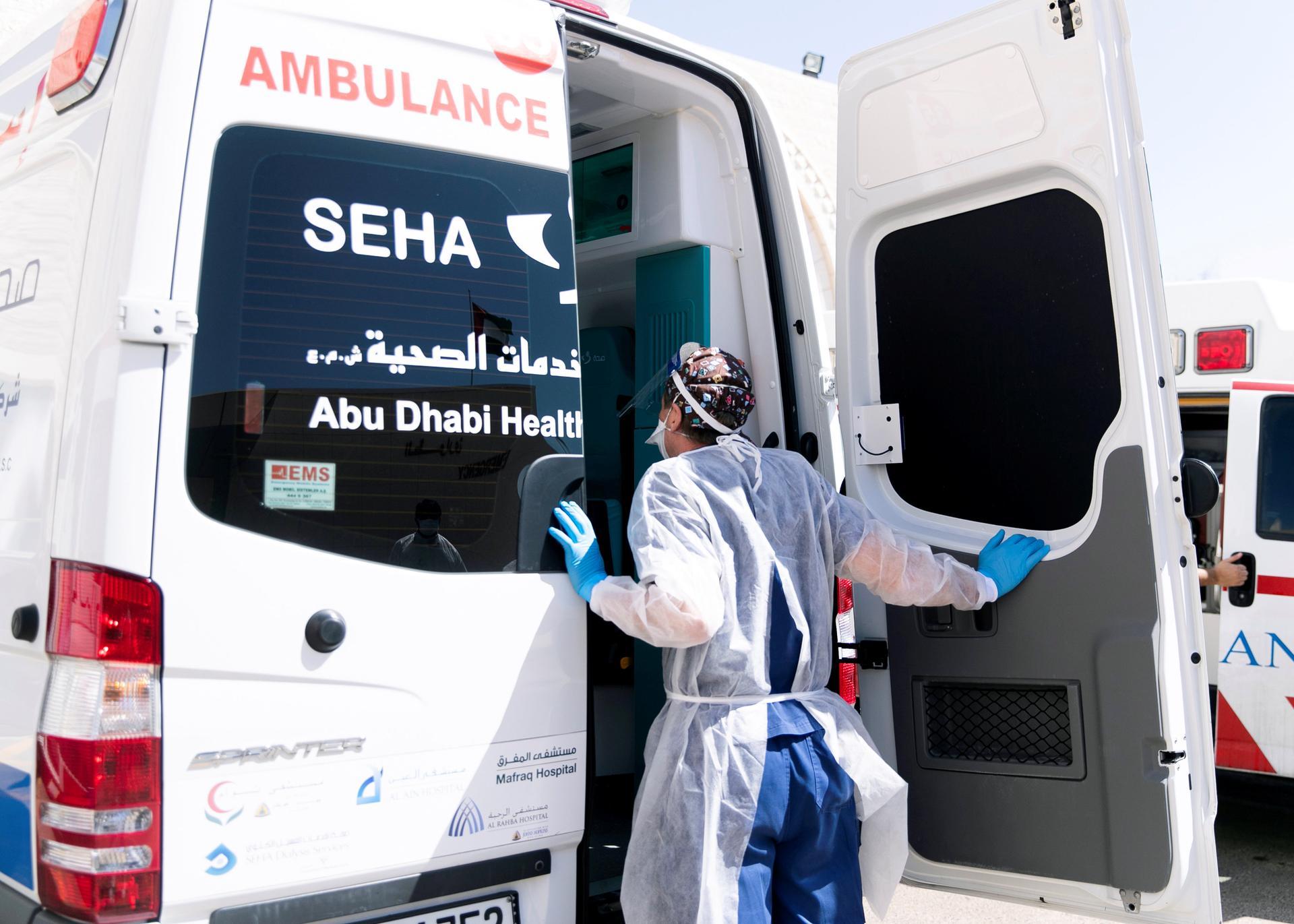 A consultant physician at the emergency department in Sheikh Khalifa Medical City, receives a Covid-19 patient. Reem Mohammed / The National