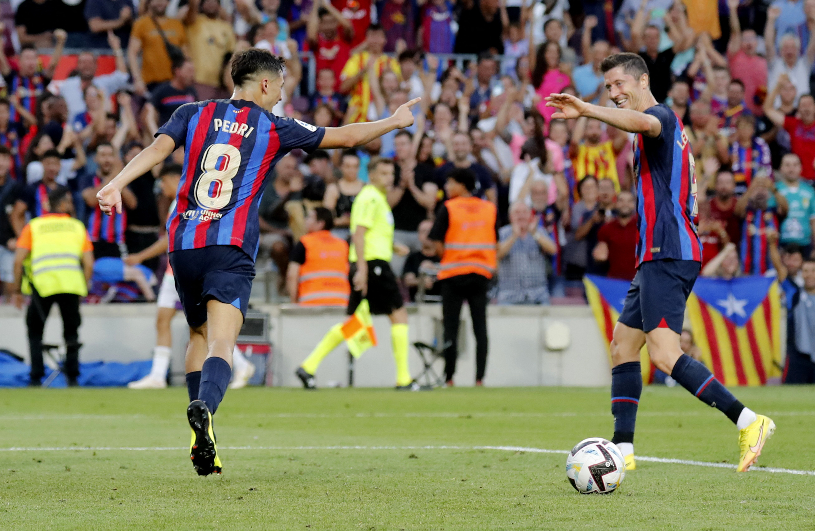 Pedri celebrates scoring Barcelona's second goal with Robert Lewandowski. Reuters