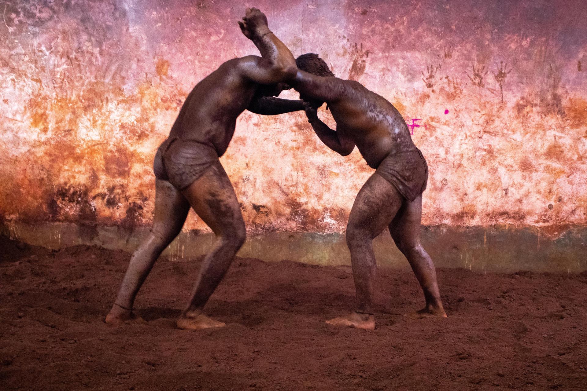 Wrestler throwing soil on himself | Mitchell Kanashkevich Travel Photography