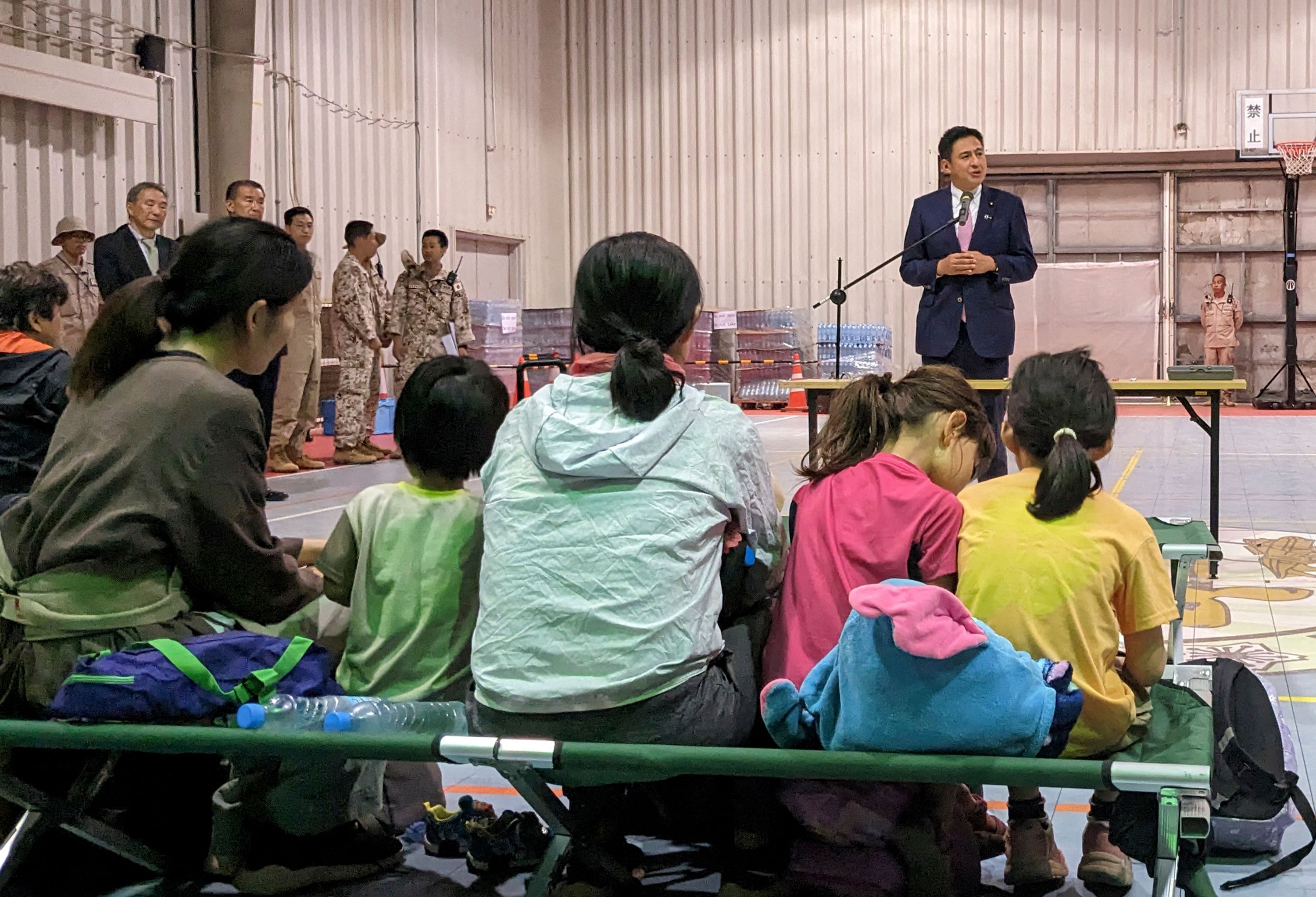 Japan's senior Vice Foreign Minister Shunsuke Takei welcomes his country's citizens in Djibouti after they were rescued from Sudan. AFP