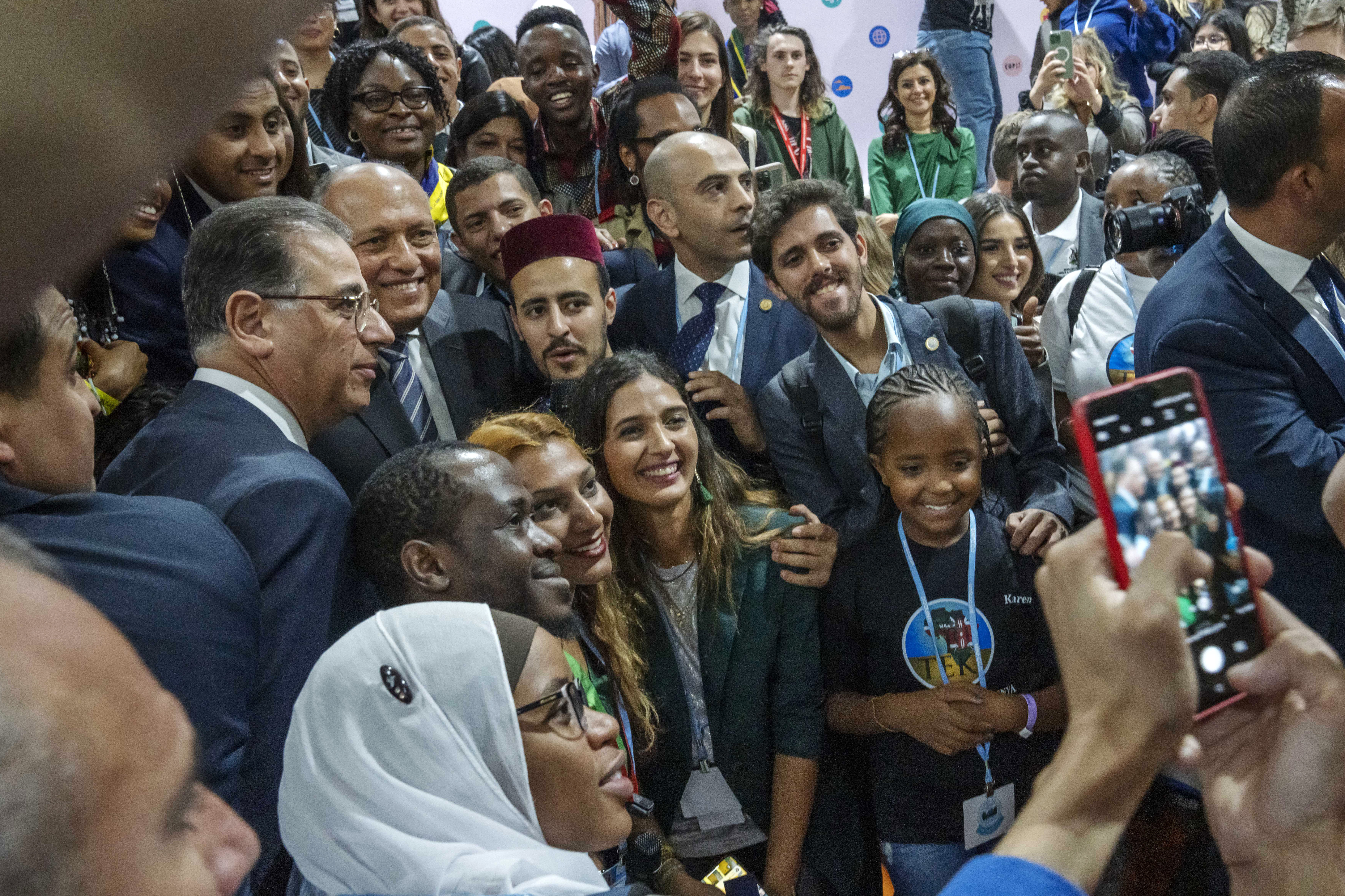 Sameh Shoukry, Cop27 president, centre left, poses for photos in the youth pavilion. AP