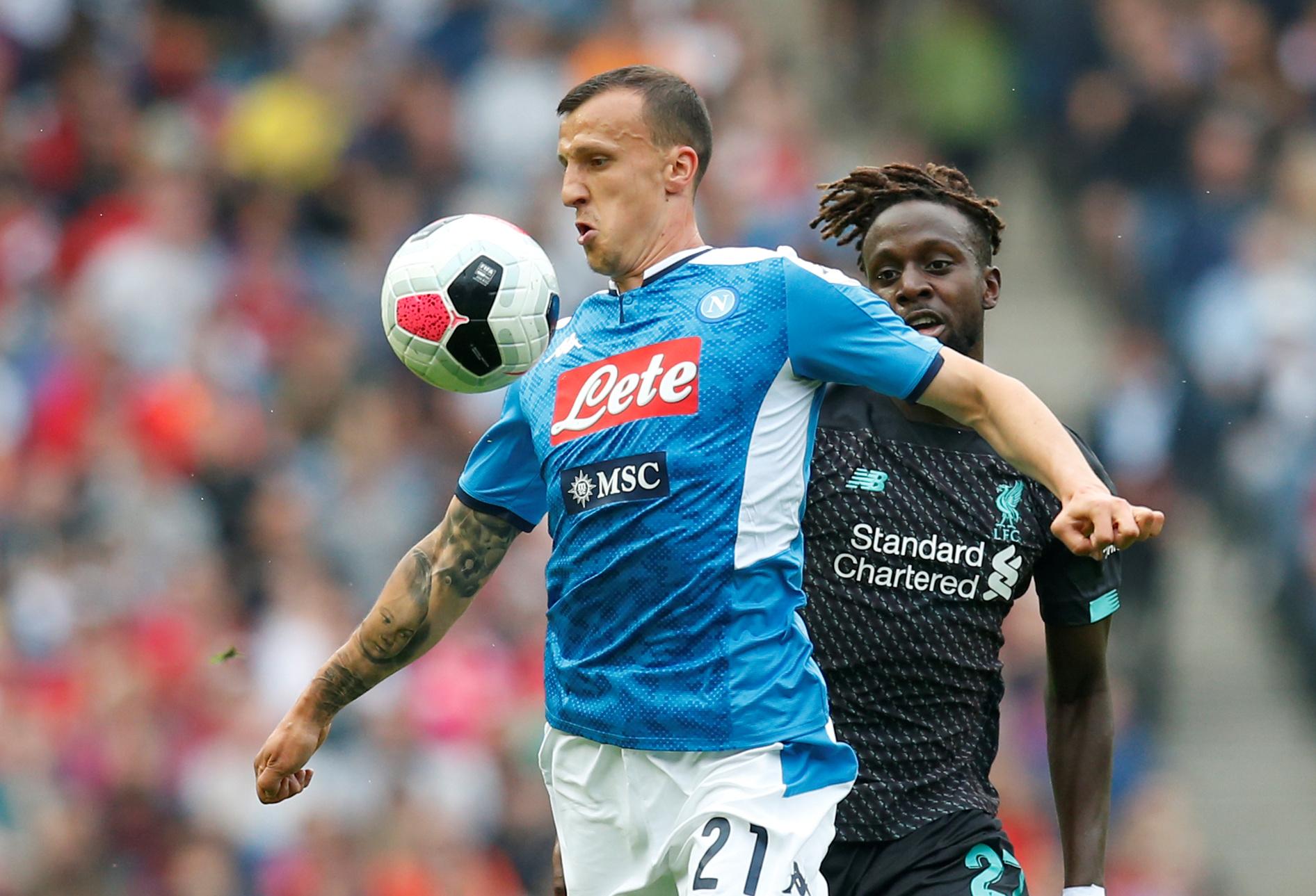 Napoli's Vlad Chiriches in action with Liverpool's Divock Origi. Reuters