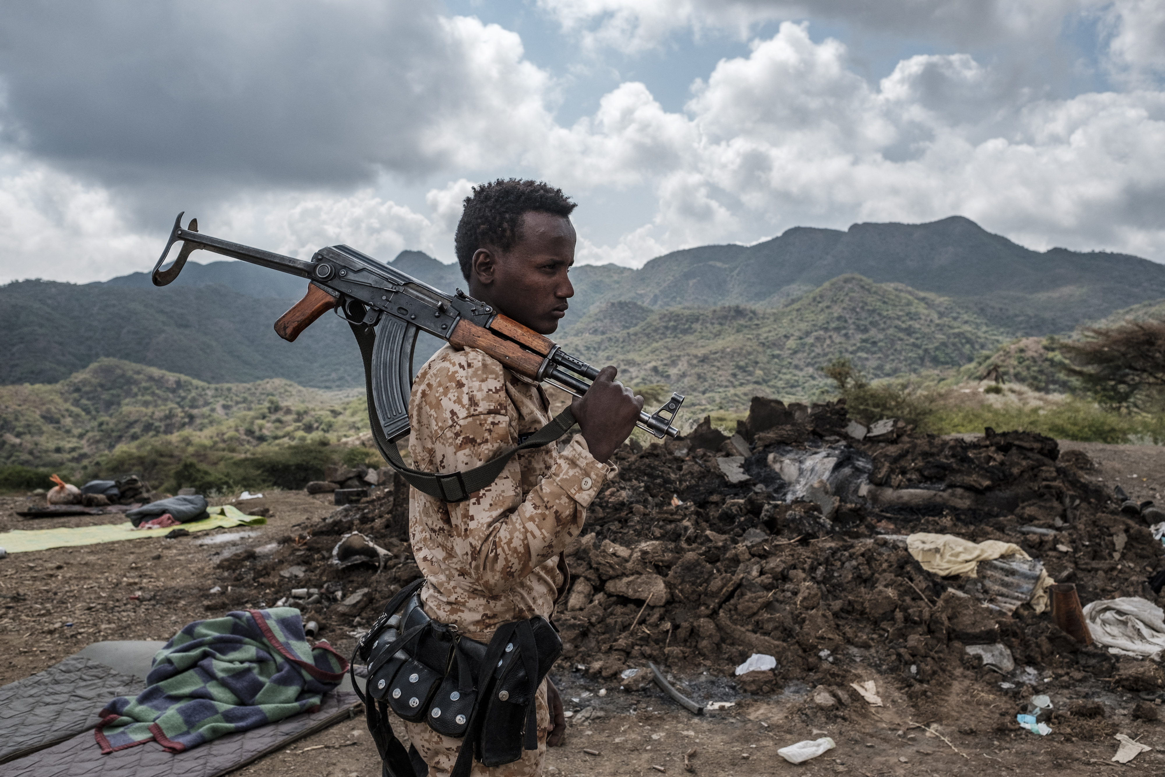 A member of the Afar Special Forces stands in front of the debris of a house on the outskirts of the village of Bisober in Tigray.