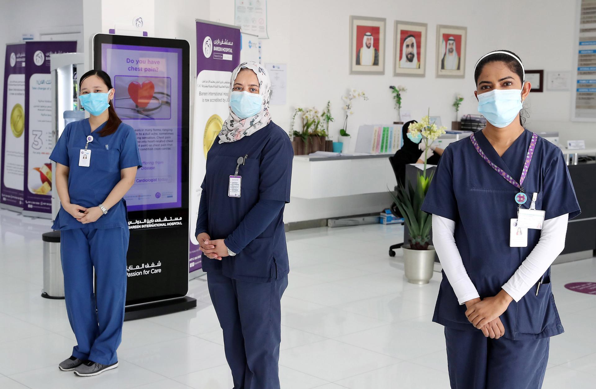 Shane Simeon Galang from Philippines, Mervat Aslan Mhgoub Mohamed from Egypt and Sowmya Kotian from India, who are nurses at the Bareen International Hospital in Mohamed bin Zayed City in Abu Dhabi. Pawan Singh / The National