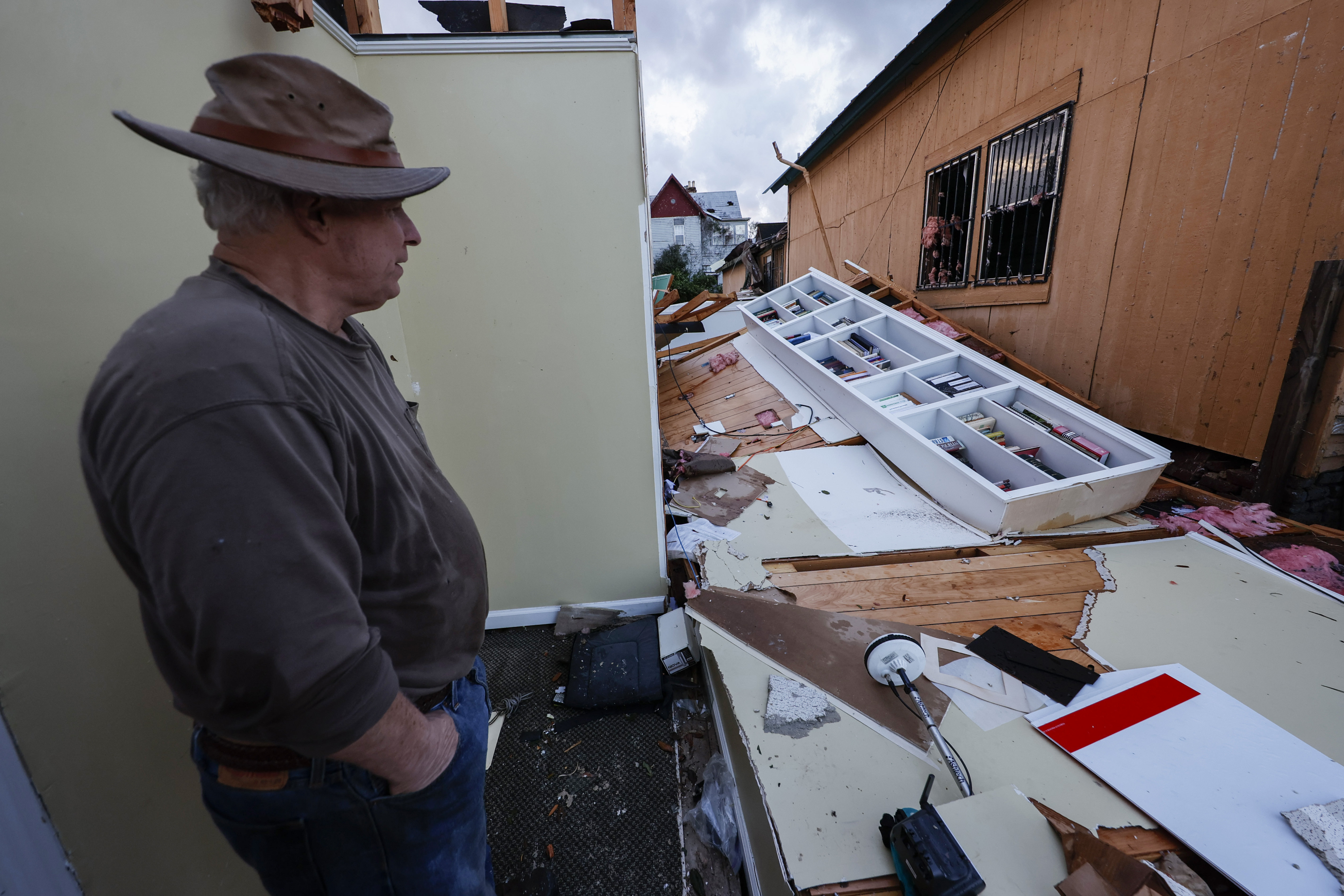 Mel Gilmer surveys the damage to his business in Selma. AP