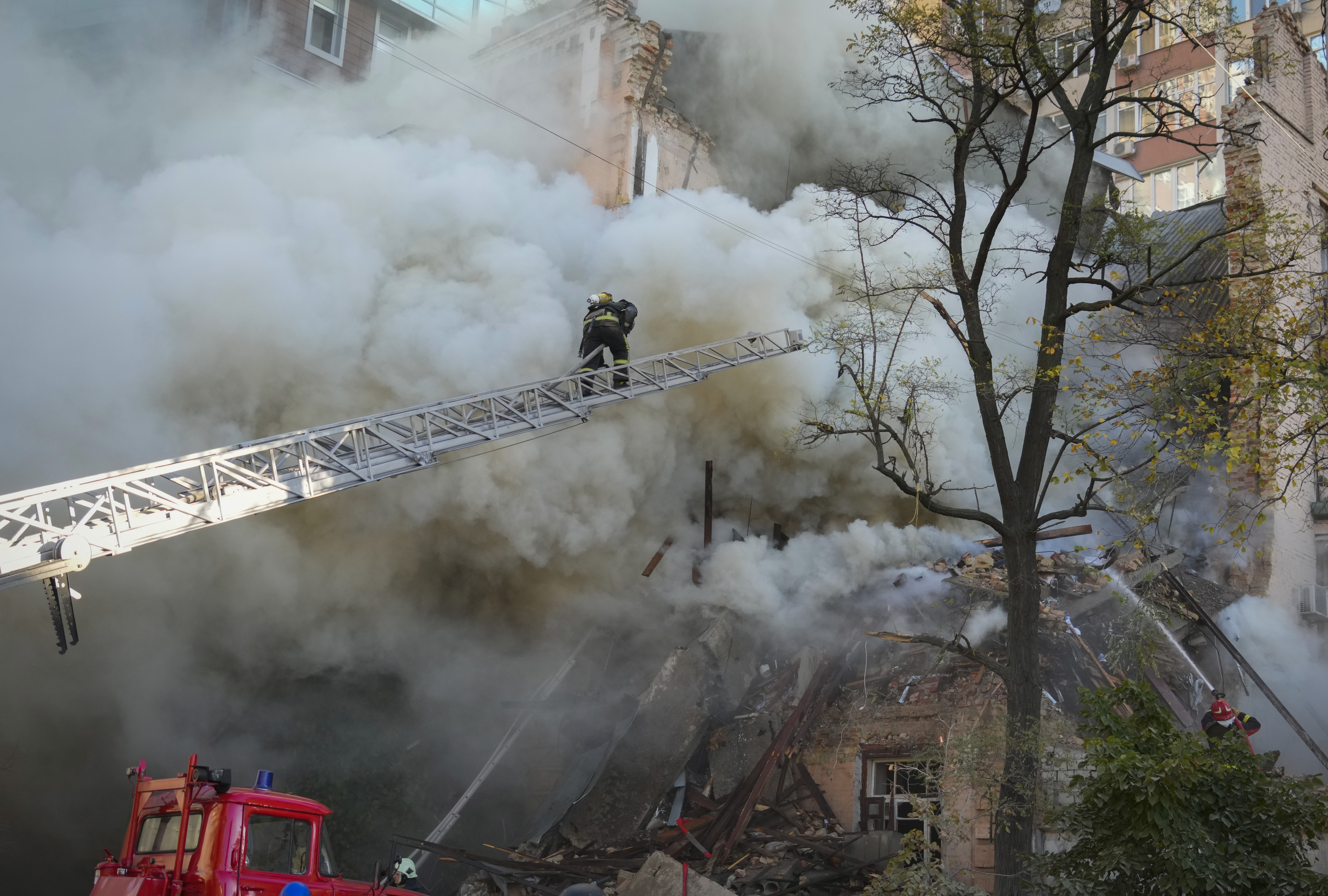 Firefighters in action after a drone fired on buildings in Kyiv, Ukraine. AP
