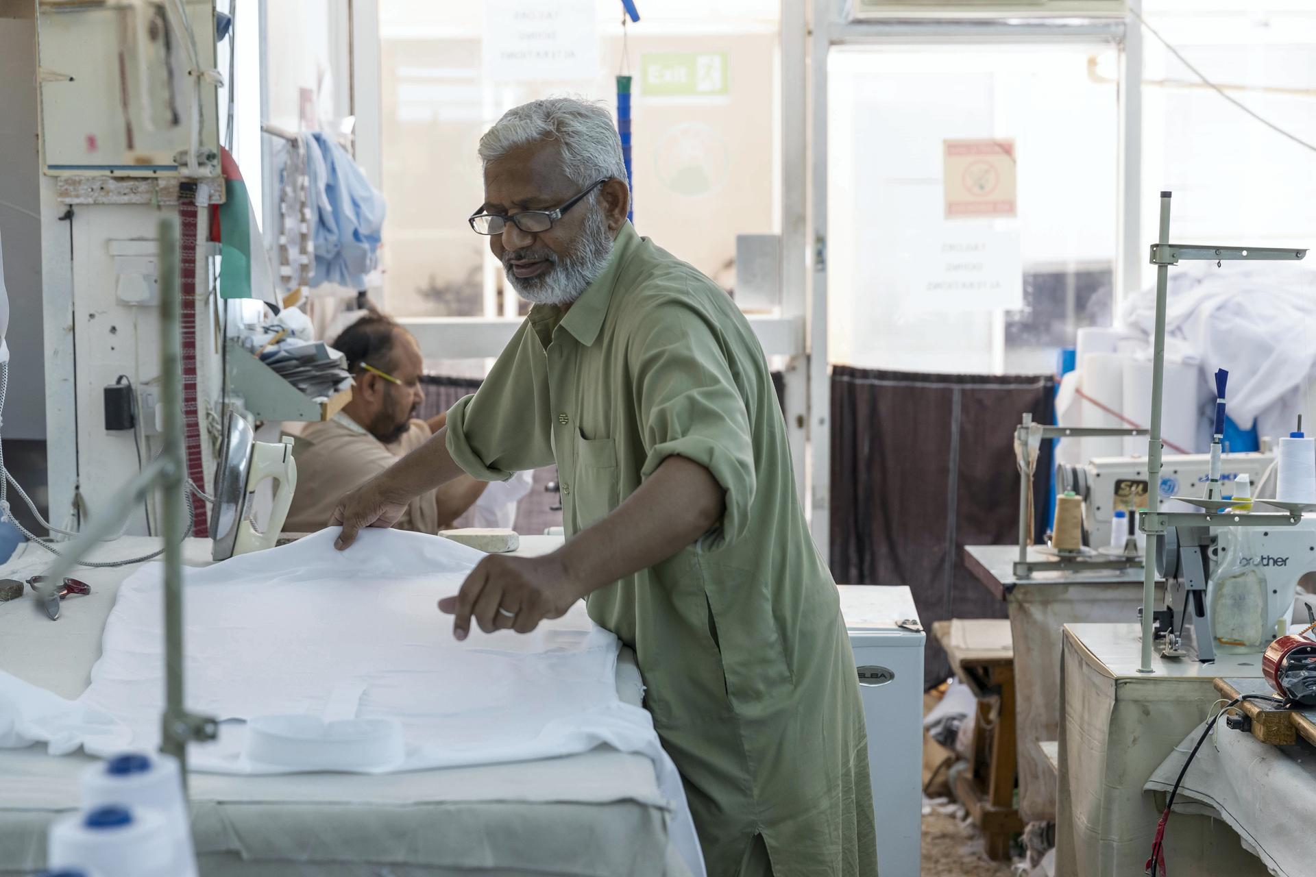 Tailors at a garment shop in Satwa prepare and finish sowing Eid clothes for the upcoming end of the Holy Month of Ramadan. Antonie Robertson / The National