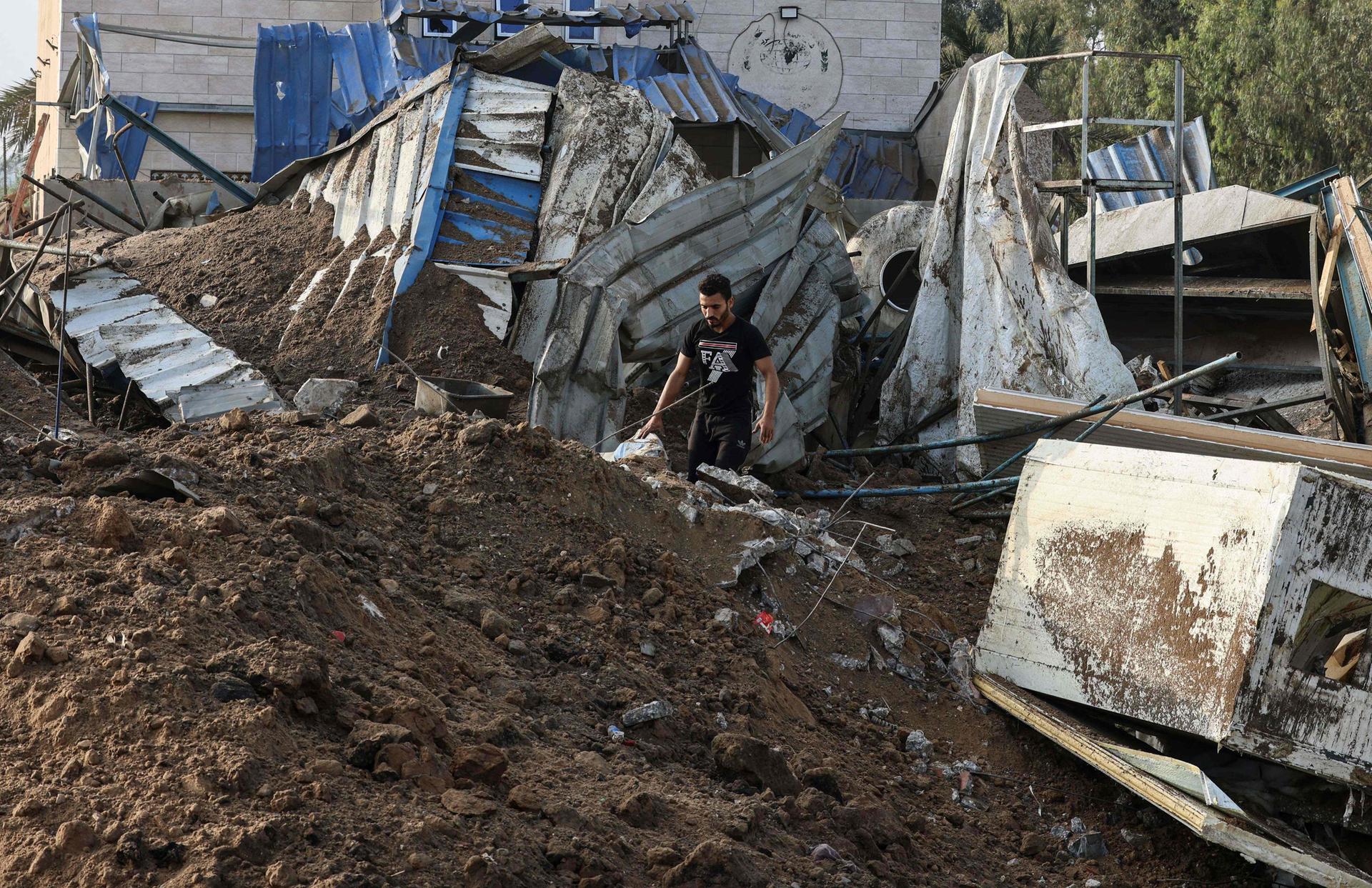 A man inspects the rubbles of a building destroyed by Israeli air strikes in Gaza. AFP