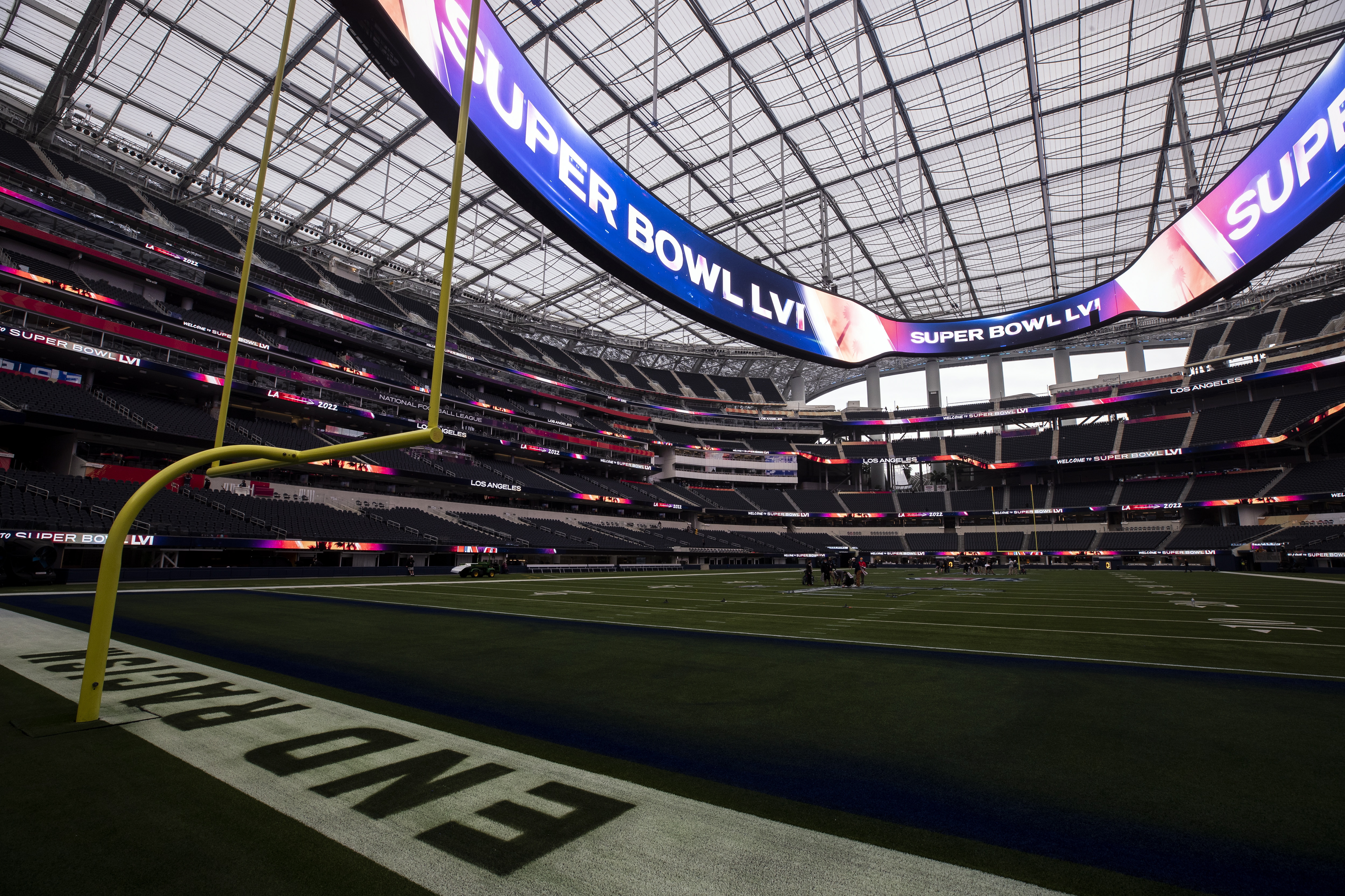 01 February 2022, US, Inglewood: Workers paint the Super Bowl LVI logo on  the field at SoFi Stadium. The Los Angeles Rams and Cincinnati Bengals will  meet here on Feb. 13, 2022 (