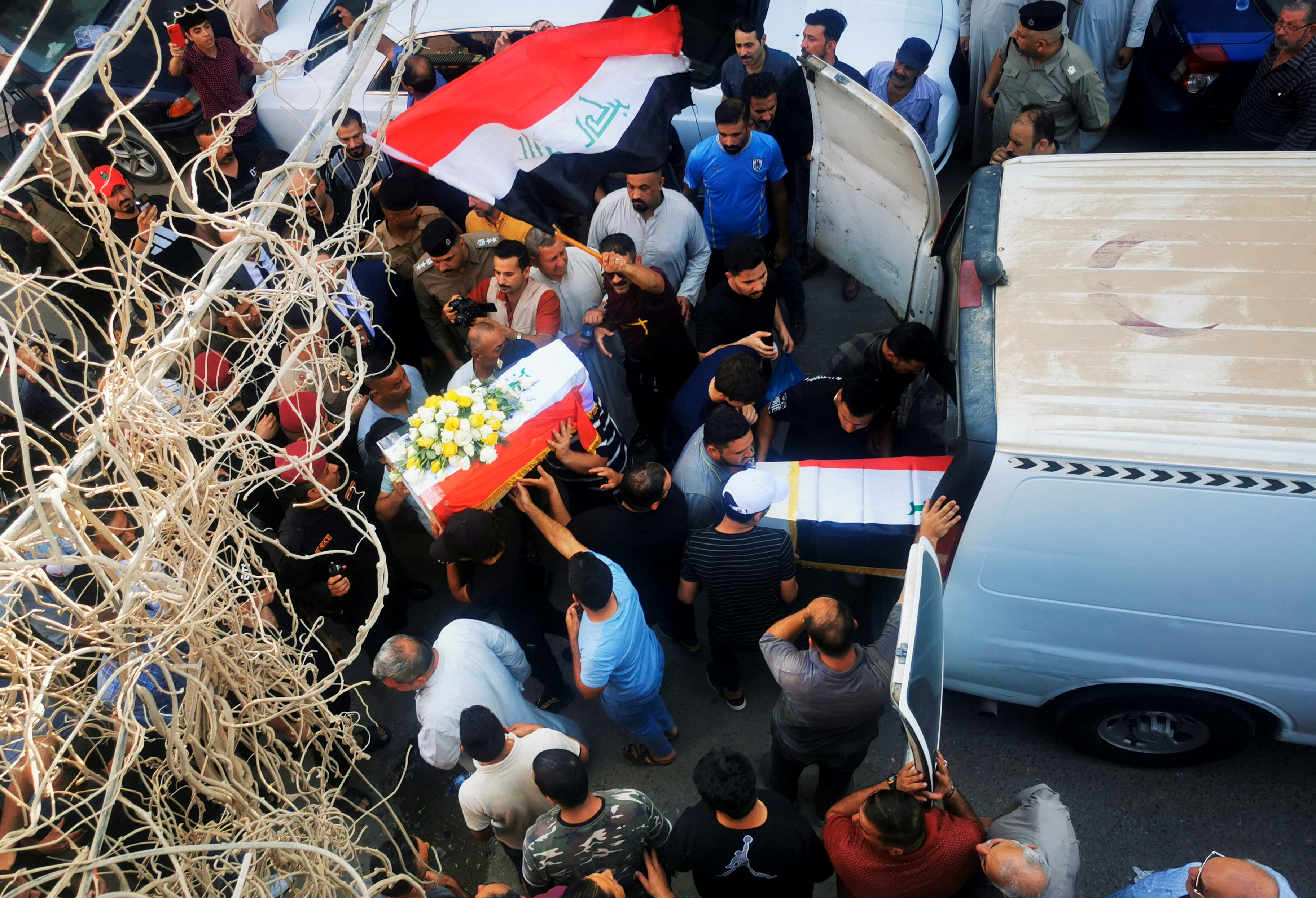 Mourners carry the coffins of people who were killed in the shelling of a mountain resort in Iraq's northern province of Dohuk. Reuters