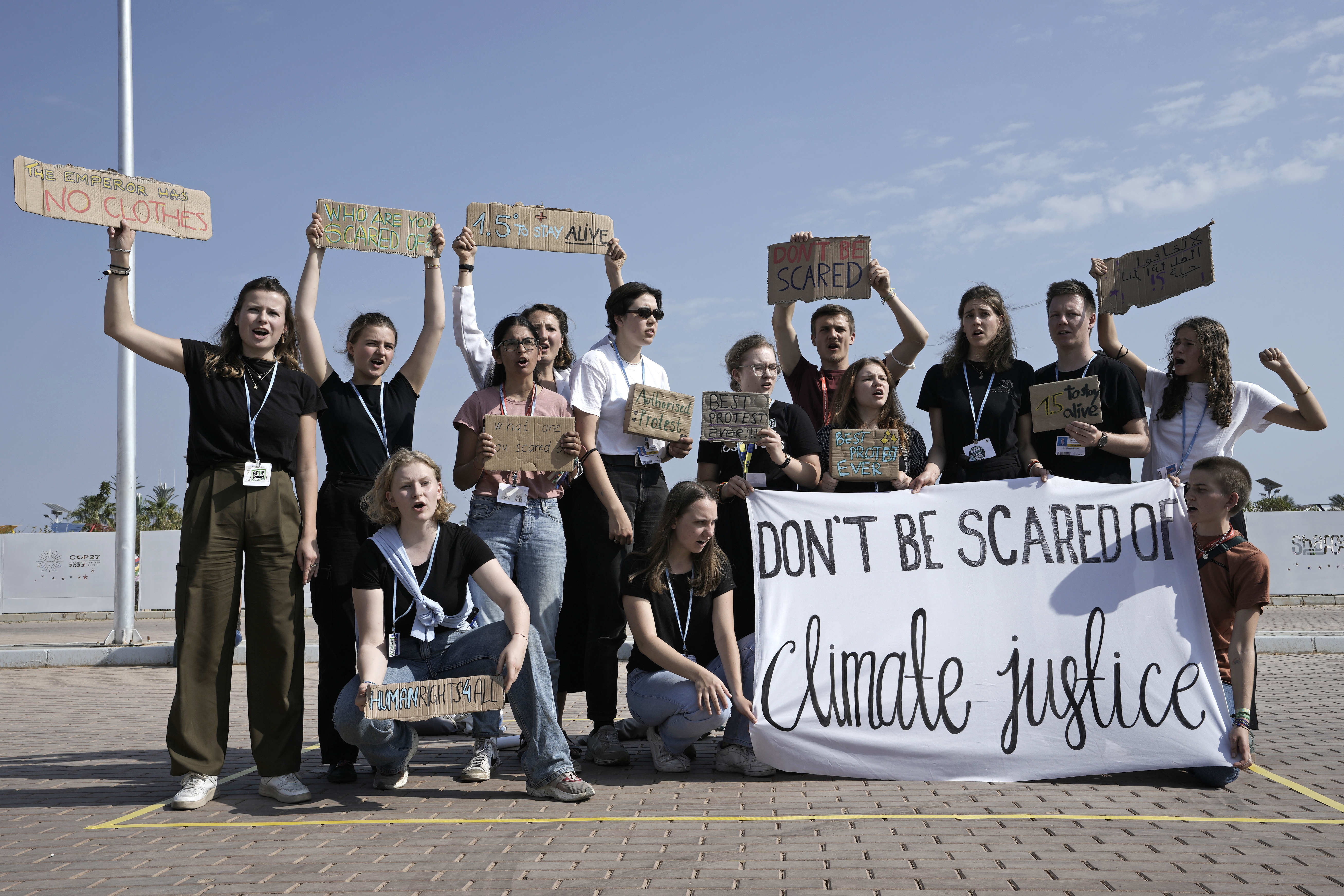 Climate activists demonstrate in the designated protest zone. AP